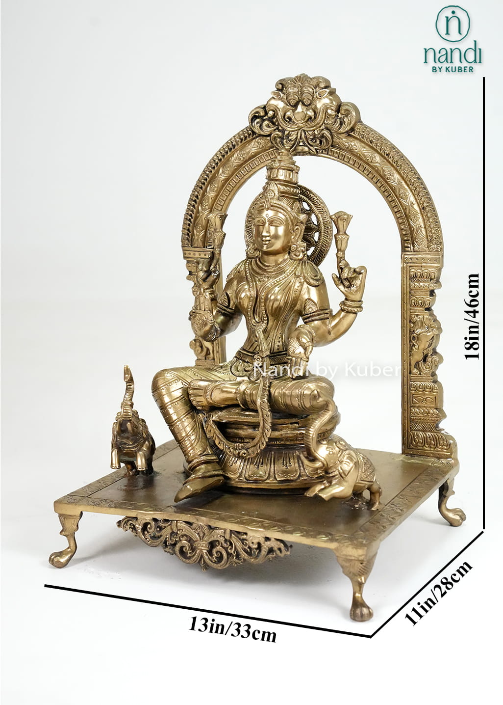 Bronze Mariamman statue with ornate arch and traditional temple-style detailing