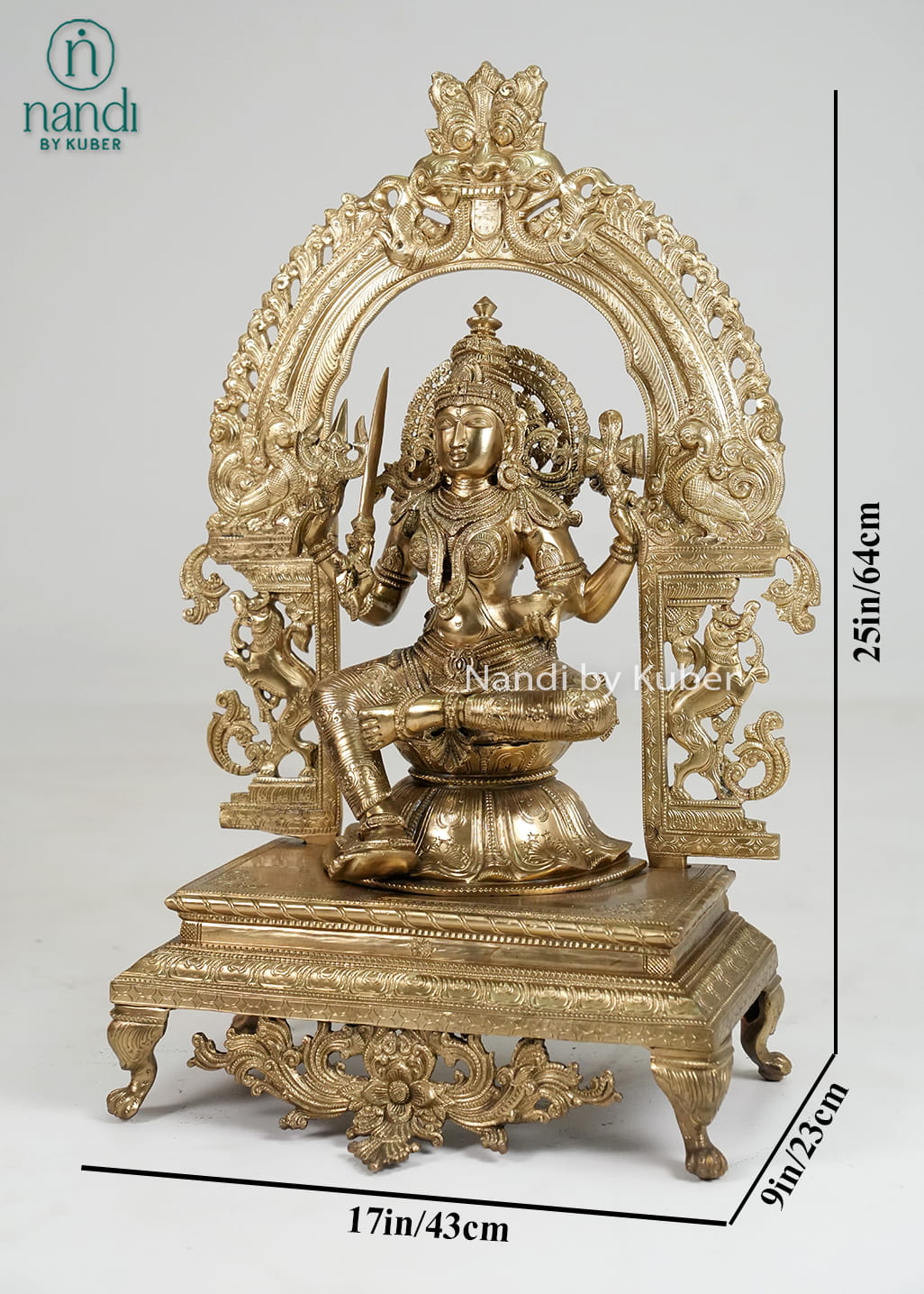Bronze Mariamman statue with ornate arch and traditional temple-style detailing