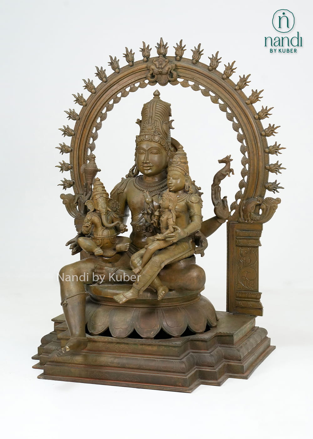 Bronze-finish Shiva Parvati family statue with Lord Ganesha, ornate arch detailing, and an intricately crafted pedestal base.