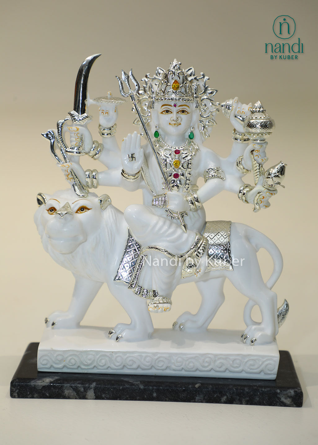 Handcrafted white marble Durga Maa statue on lion with silver and traditional craftsmanship, ideal for pooja rooms, spiritual décor, temple settings, and religious gifting.