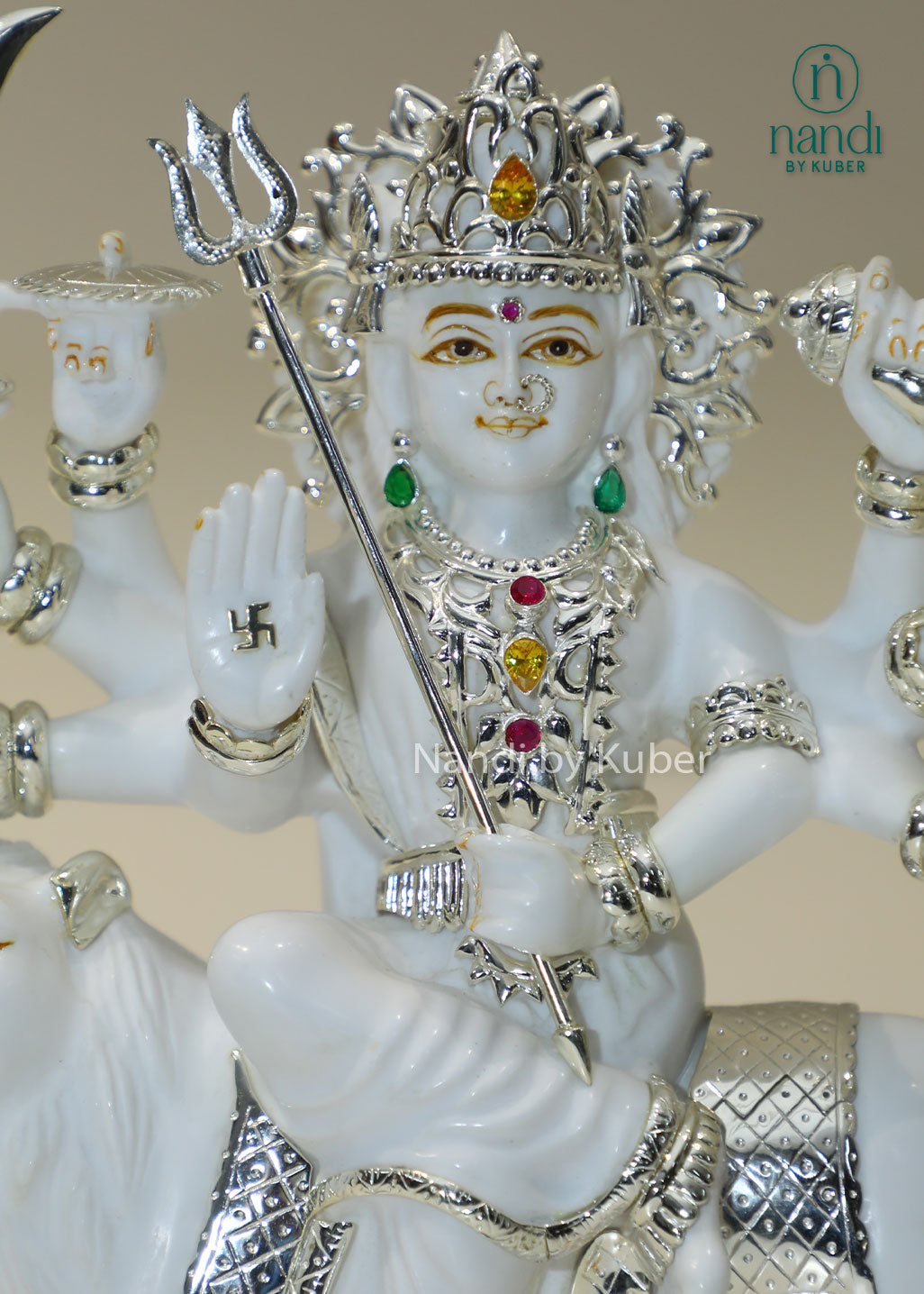 Handcrafted white marble Durga Maa statue on lion with silver and traditional craftsmanship, ideal for pooja rooms, spiritual décor, temple settings, and religious gifting.