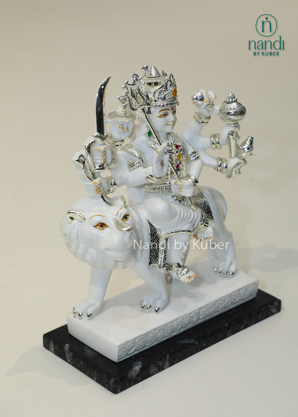Handcrafted white marble Durga Maa statue on lion with silver and traditional craftsmanship, ideal for pooja rooms, spiritual décor, temple settings, and religious gifting.