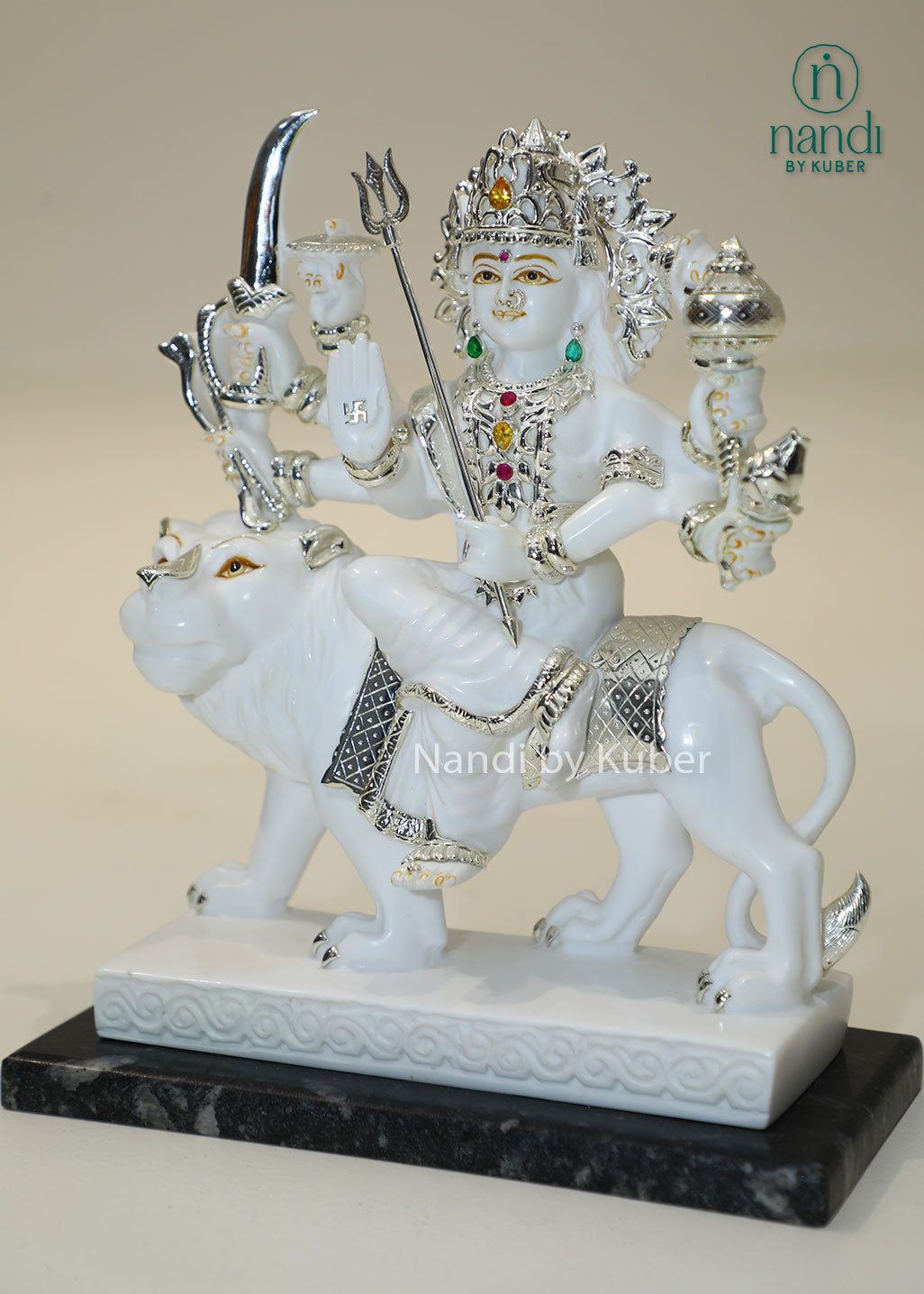 Handcrafted white marble Durga Maa statue on lion with silver and traditional craftsmanship, ideal for pooja rooms, spiritual décor, temple settings, and religious gifting.