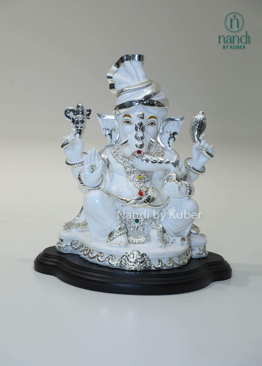 White marble Ganesha idol with silver detailing and gemstone accents, Lord Ganesh statue for home temple, pooja room décor, Vastu, prosperity, wealth attraction, positive energy, spiritual worship, festive gifting, and office decoration.