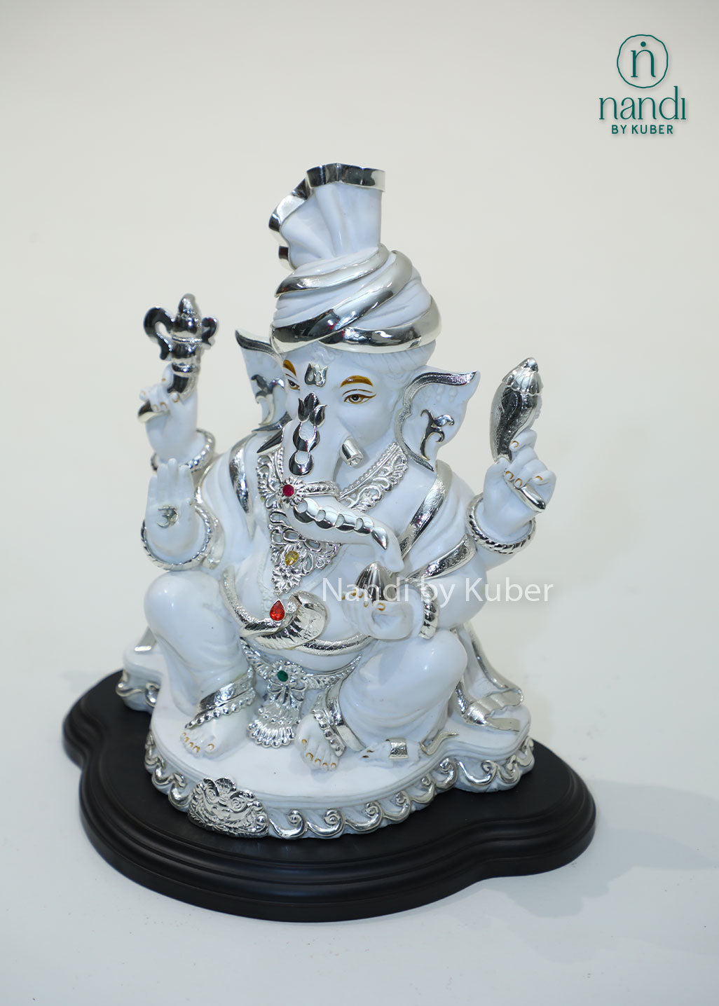 White marble Ganesha idol with silver detailing and gemstone accents, Lord Ganesh statue for home temple, pooja room décor, Vastu, prosperity, wealth attraction, positive energy, spiritual worship, festive gifting, and office decoration.