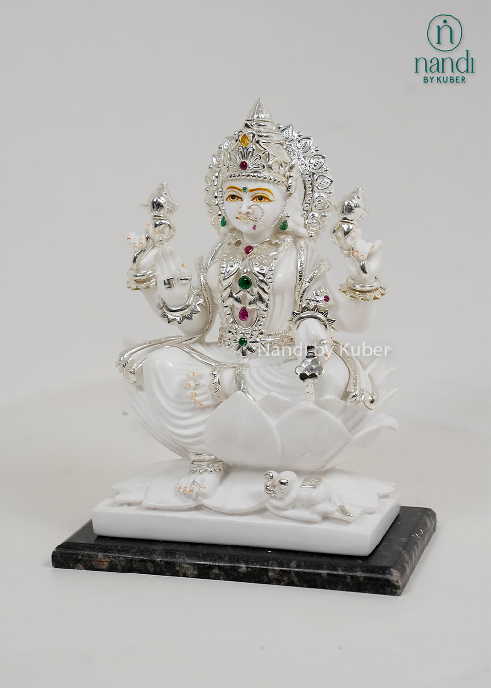 White marble Lakshmi statue seated on a lotus