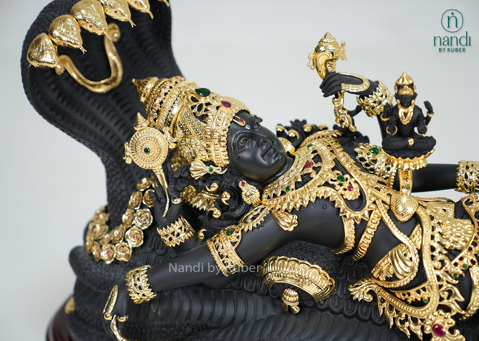 Black marble Padmanabha Swamy idol with gold detailing and decorative display base