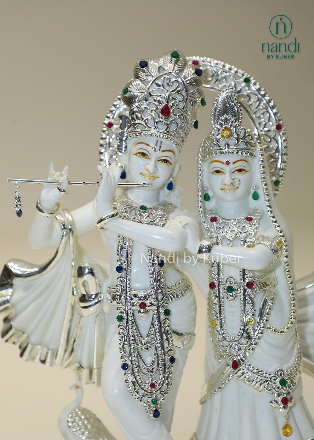Marble Radha Krishna idol with silver embellishments and gemstone accents, divine Jugal Jodi statue for home temple, pooja room décor, spiritual worship, Vastu, meditation, festive gifting, love, harmony, and devotion.
