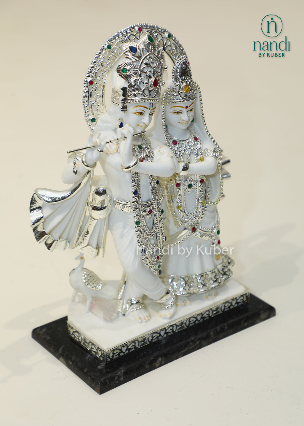 Marble Radha Krishna idol with silver embellishments and gemstone accents, divine Jugal Jodi statue for home temple, pooja room décor, spiritual worship, Vastu, meditation, festive gifting, love, harmony, and devotion.