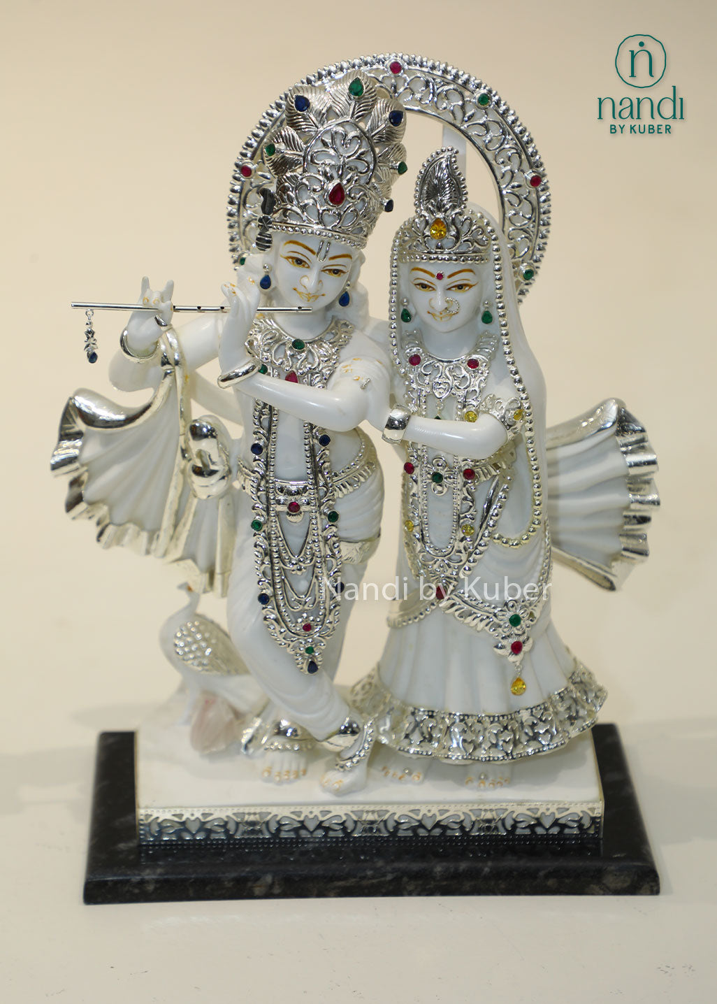 Marble Radha Krishna idol with silver embellishments and gemstone accents, divine Jugal Jodi statue for home temple, pooja room décor, spiritual worship, Vastu, meditation, festive gifting, love, harmony, and devotion.