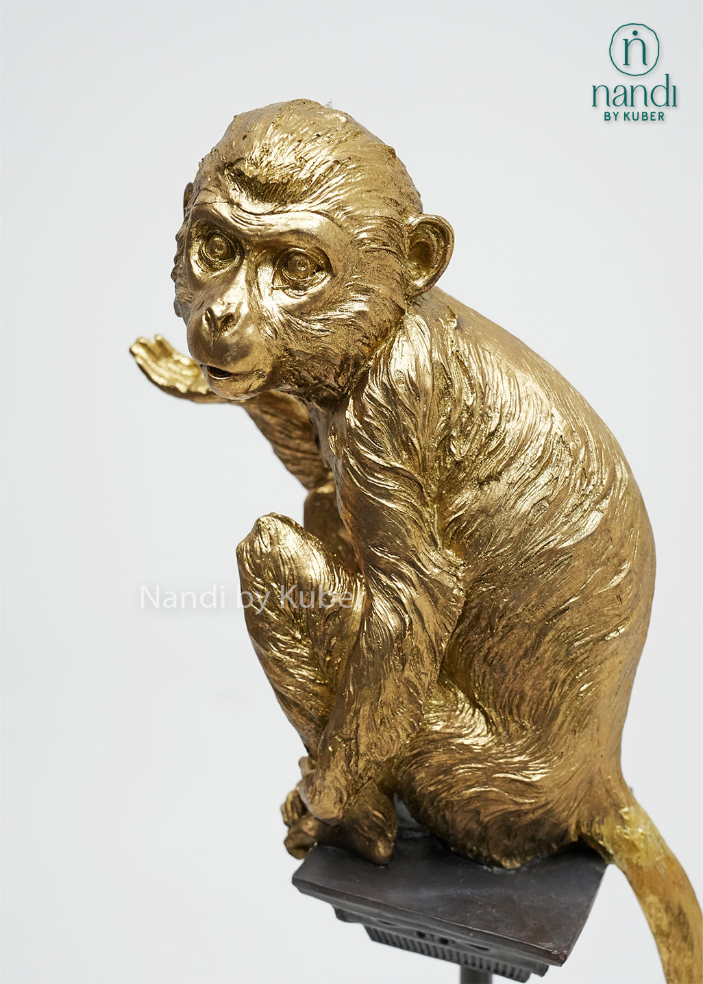 Decorative monkey figurine on a stand with an antique gold finish, bringing personality, charm, and artistic elegance to any interior space.
