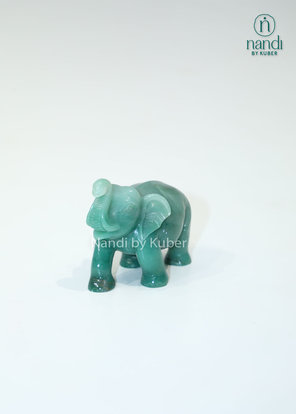 Polished jade stone elephant with an upward trunk, symbolizing luck, prosperity, and wisdom while adding elegant charm to any décor.
