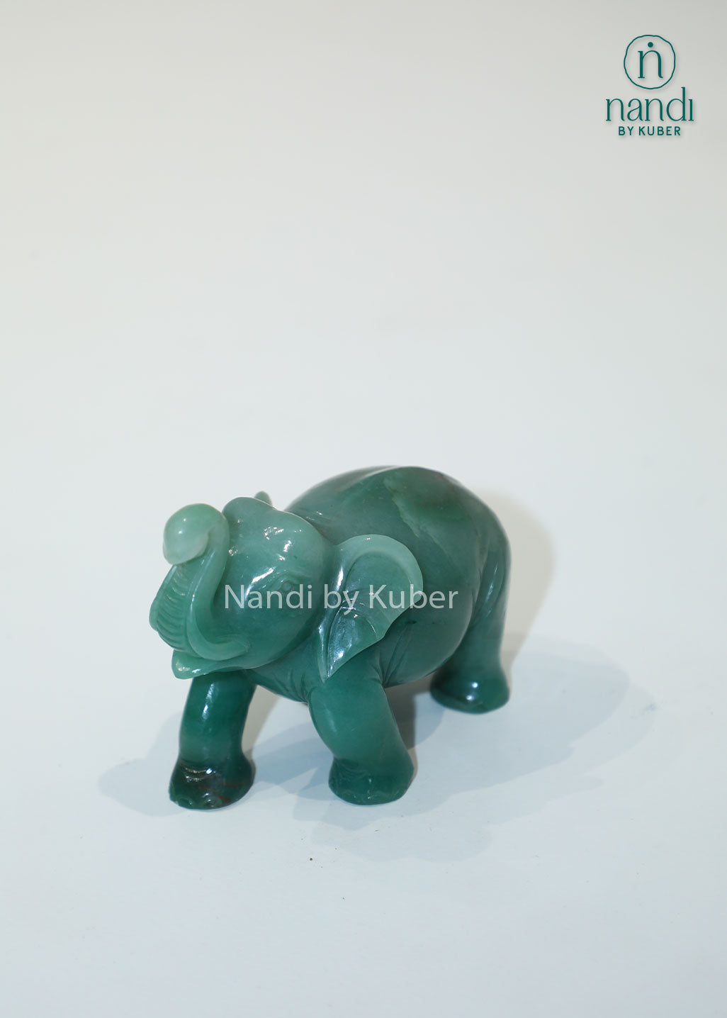 Polished jade stone elephant with an upward trunk, symbolizing luck, prosperity, and wisdom while adding elegant charm to any décor.