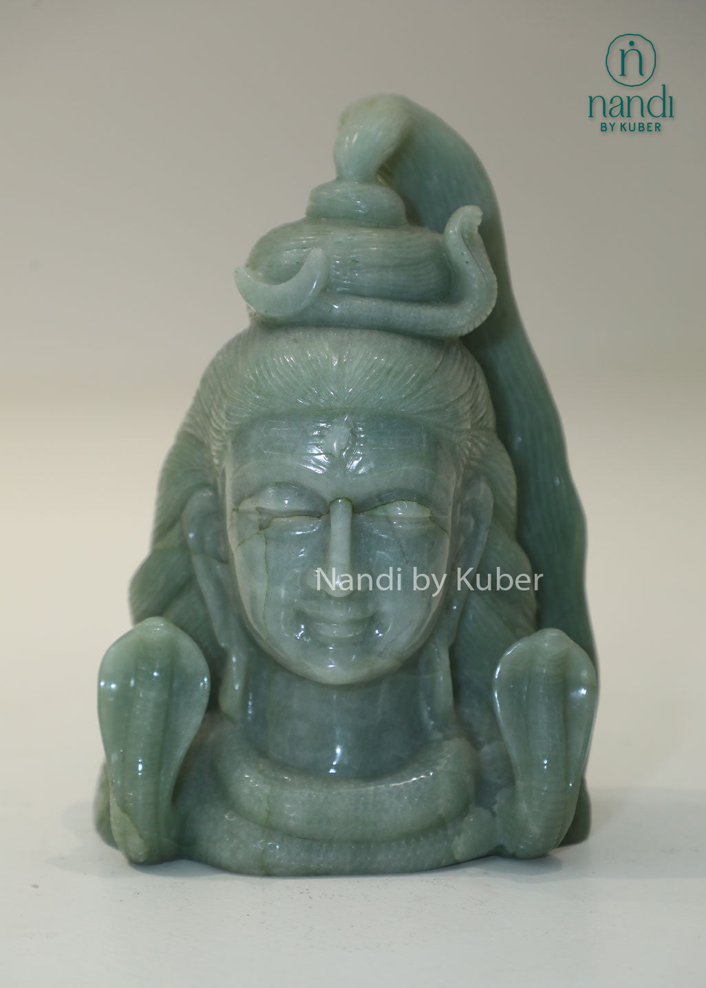 Natural Jade Stone Lord Shiva Head statue with serpent crown, spiritual Hindu deity sculpture for meditation, home temple décor, Vastu enhancement, positive energy, spiritual healing, devotional worship, and gifting.