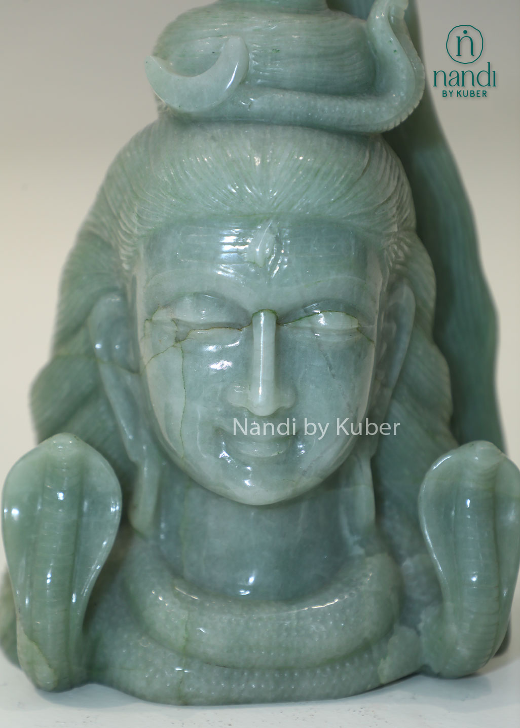 Natural Jade Stone Lord Shiva Head statue with serpent crown, spiritual Hindu deity sculpture for meditation, home temple décor, Vastu enhancement, positive energy, spiritual healing, devotional worship, and gifting.