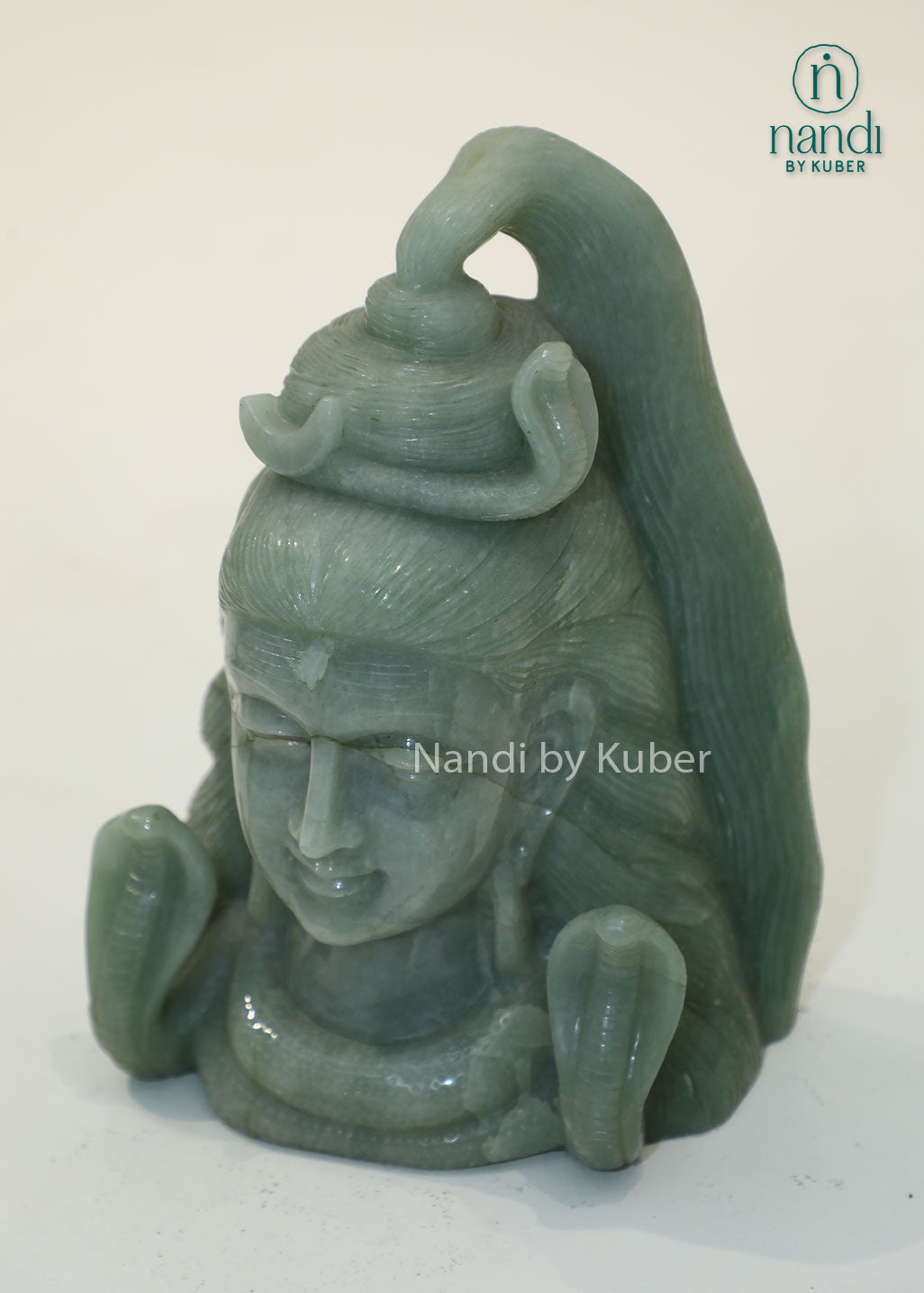 Natural Jade Stone Lord Shiva Head statue with serpent crown, spiritual Hindu deity sculpture for meditation, home temple décor, Vastu enhancement, positive energy, spiritual healing, devotional worship, and gifting.