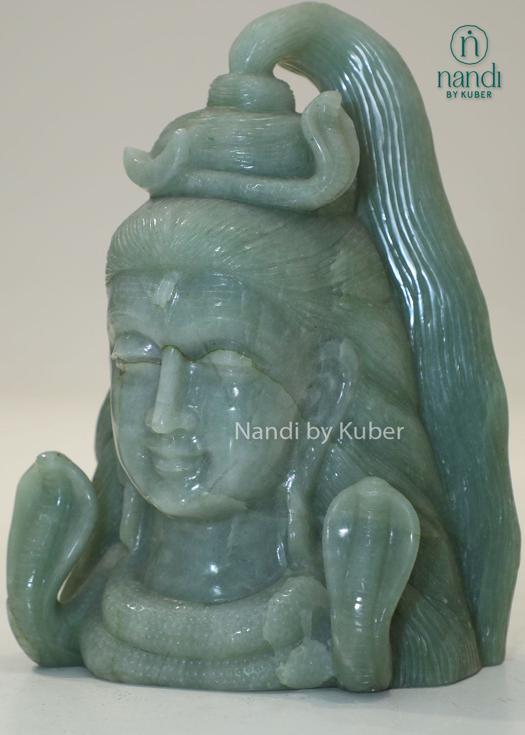 Natural Jade Stone Lord Shiva Head statue with serpent crown, spiritual Hindu deity sculpture for meditation, home temple décor, Vastu enhancement, positive energy, spiritual healing, devotional worship, and gifting.