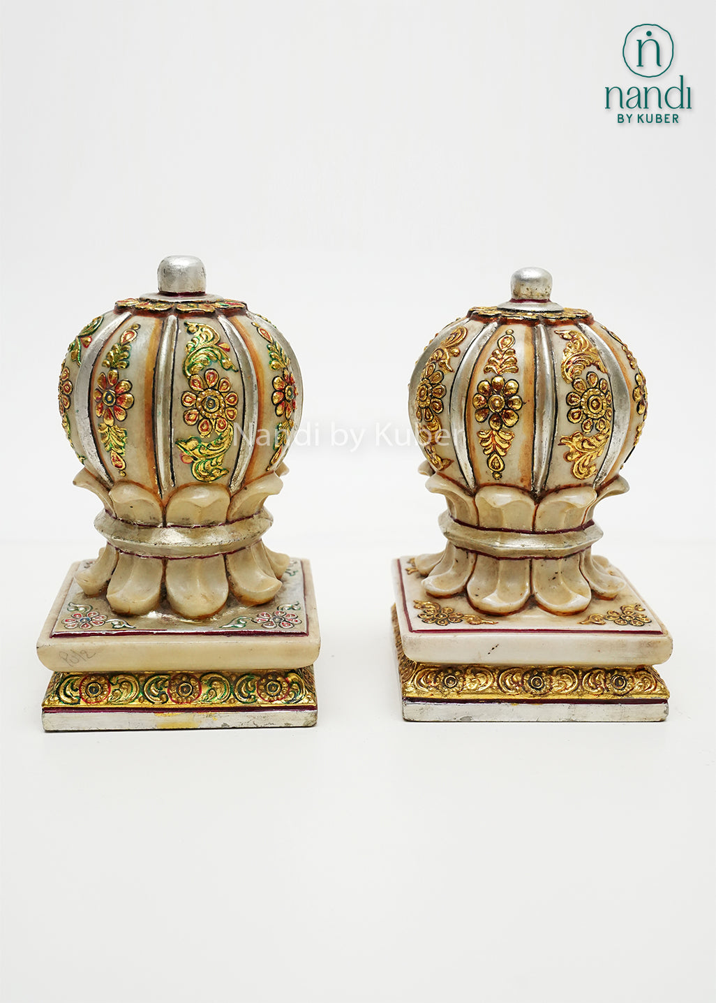 Set of two decorative marble door stoppers with intricate floral hand-painting, embossed detailing, and gold embellishments, ideal for luxury home décor and traditional Indian interiors.