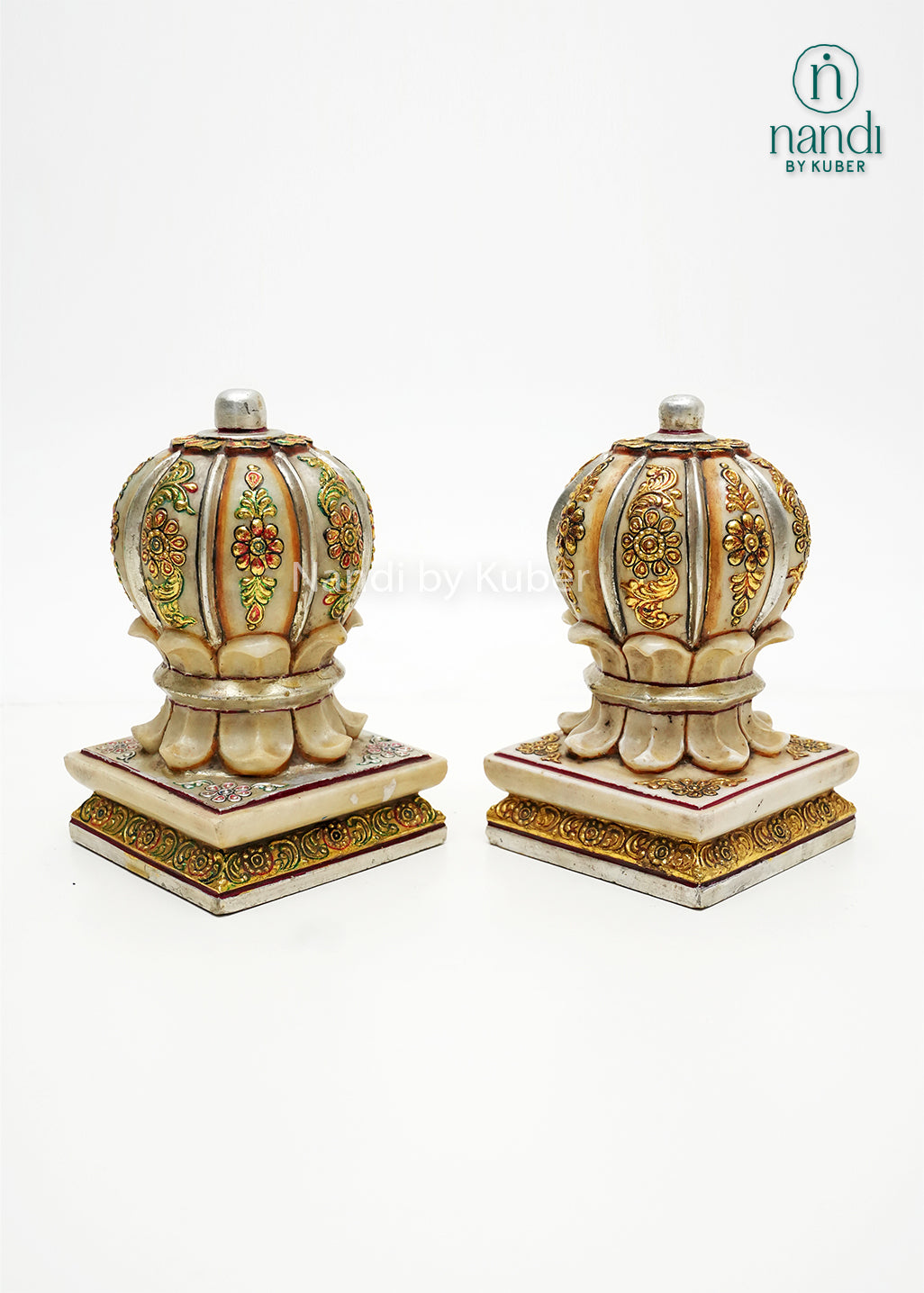 Set of two decorative marble door stoppers with intricate floral hand-painting, embossed detailing, and gold embellishments, ideal for luxury home décor and traditional Indian interiors.