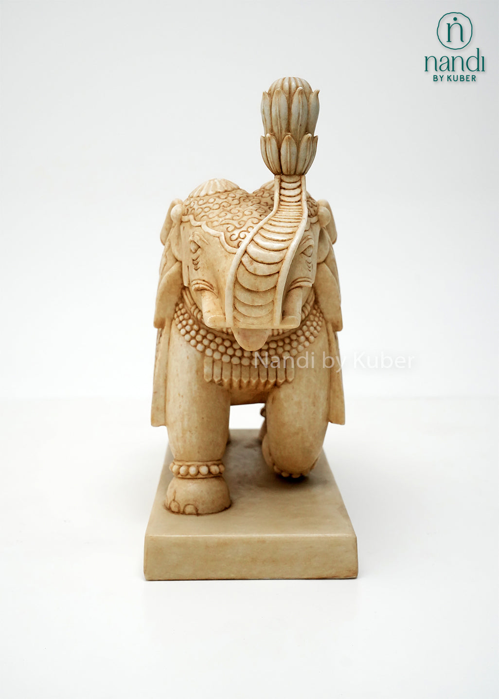 Handcrafted marble elephant statue with raised trunk, intricate traditional carvings, and decorative detailing on a marble base, ideal for home décor, Vastu, gifting, and luxury interior decoration.