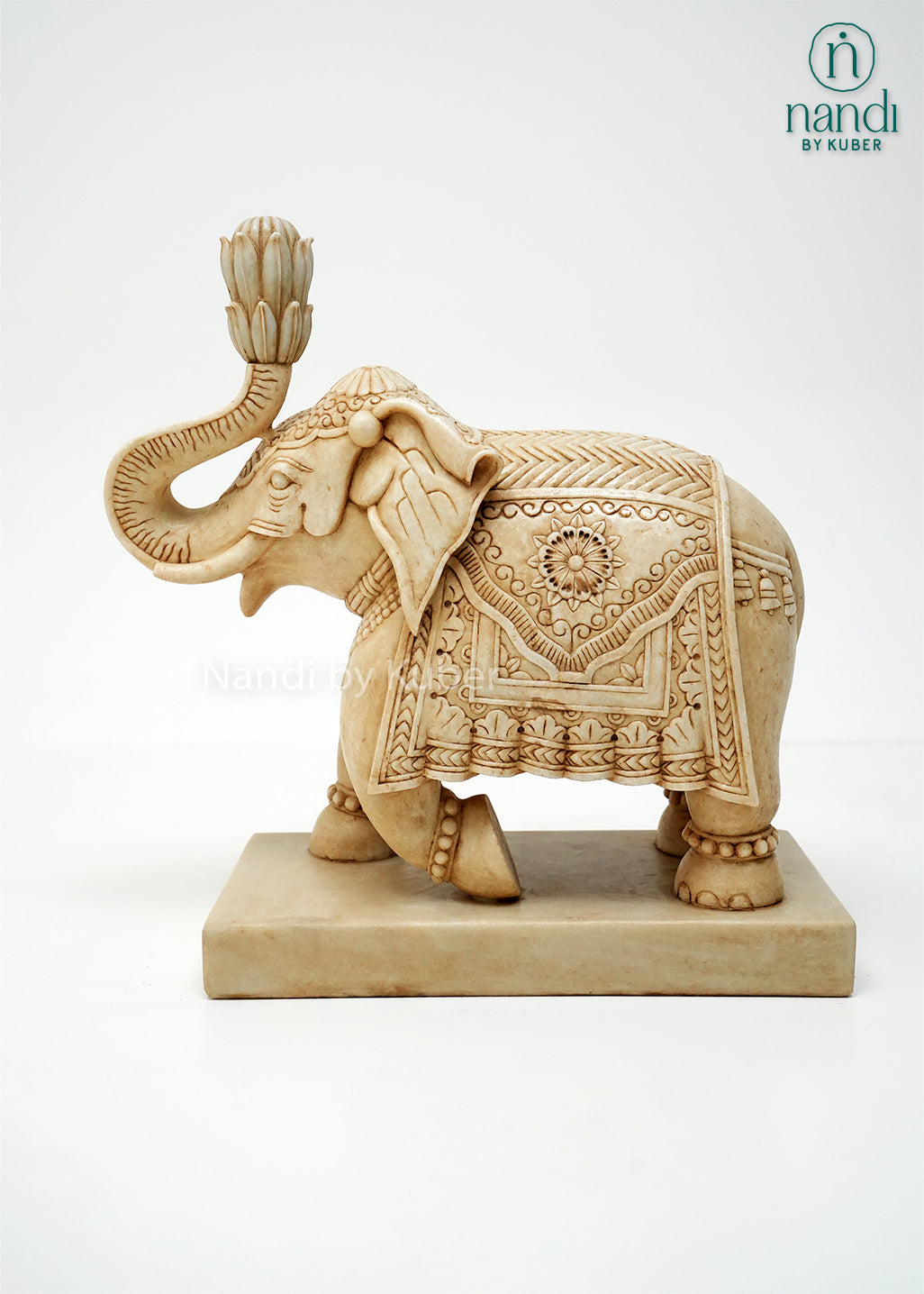 Handcrafted marble elephant statue with raised trunk, intricate traditional carvings, and decorative detailing on a marble base, ideal for home décor, Vastu, gifting, and luxury interior decoration.