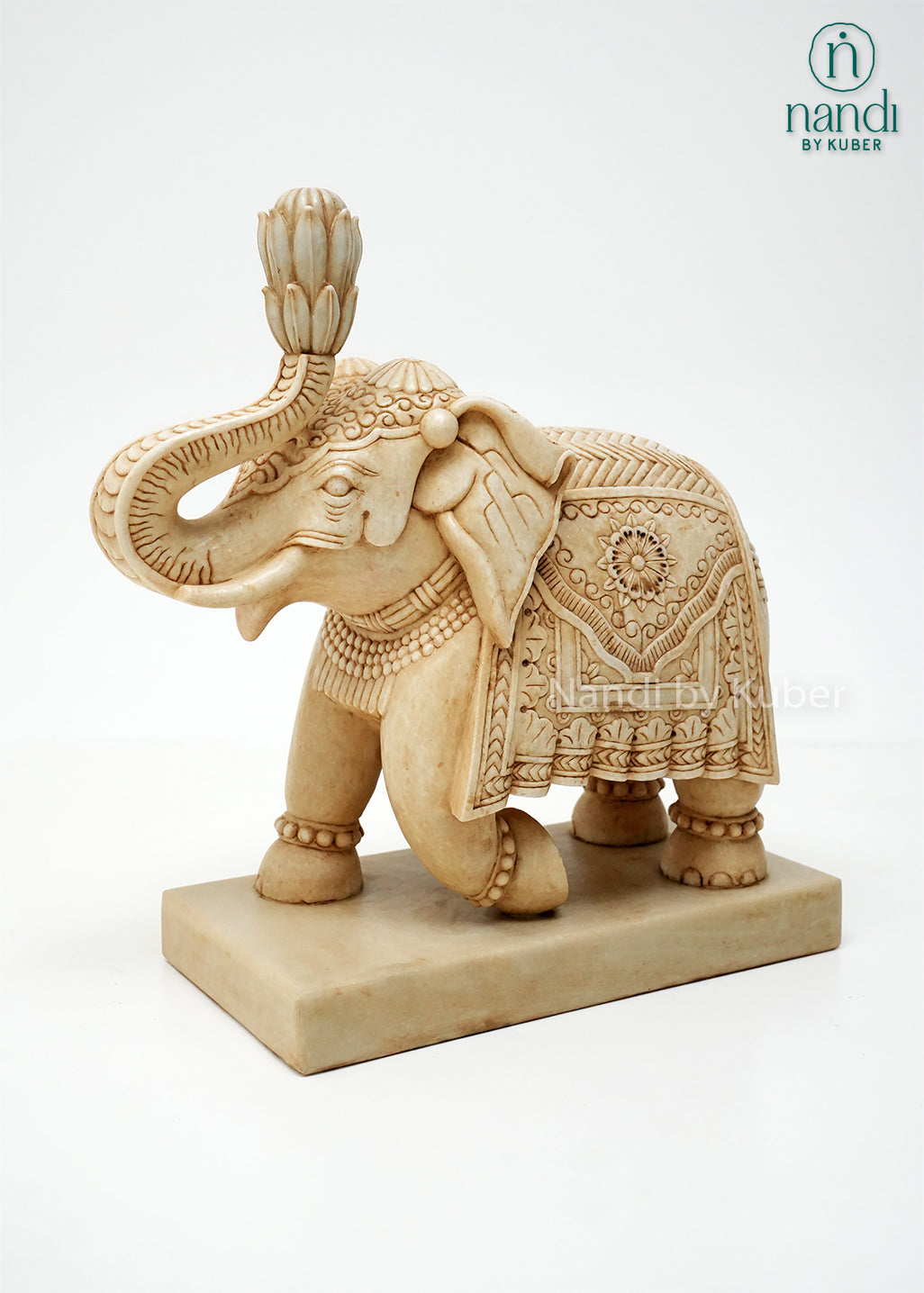 Handcrafted marble elephant statue with raised trunk, intricate traditional carvings, and decorative detailing on a marble base, ideal for home décor, Vastu, gifting, and luxury interior decoration.