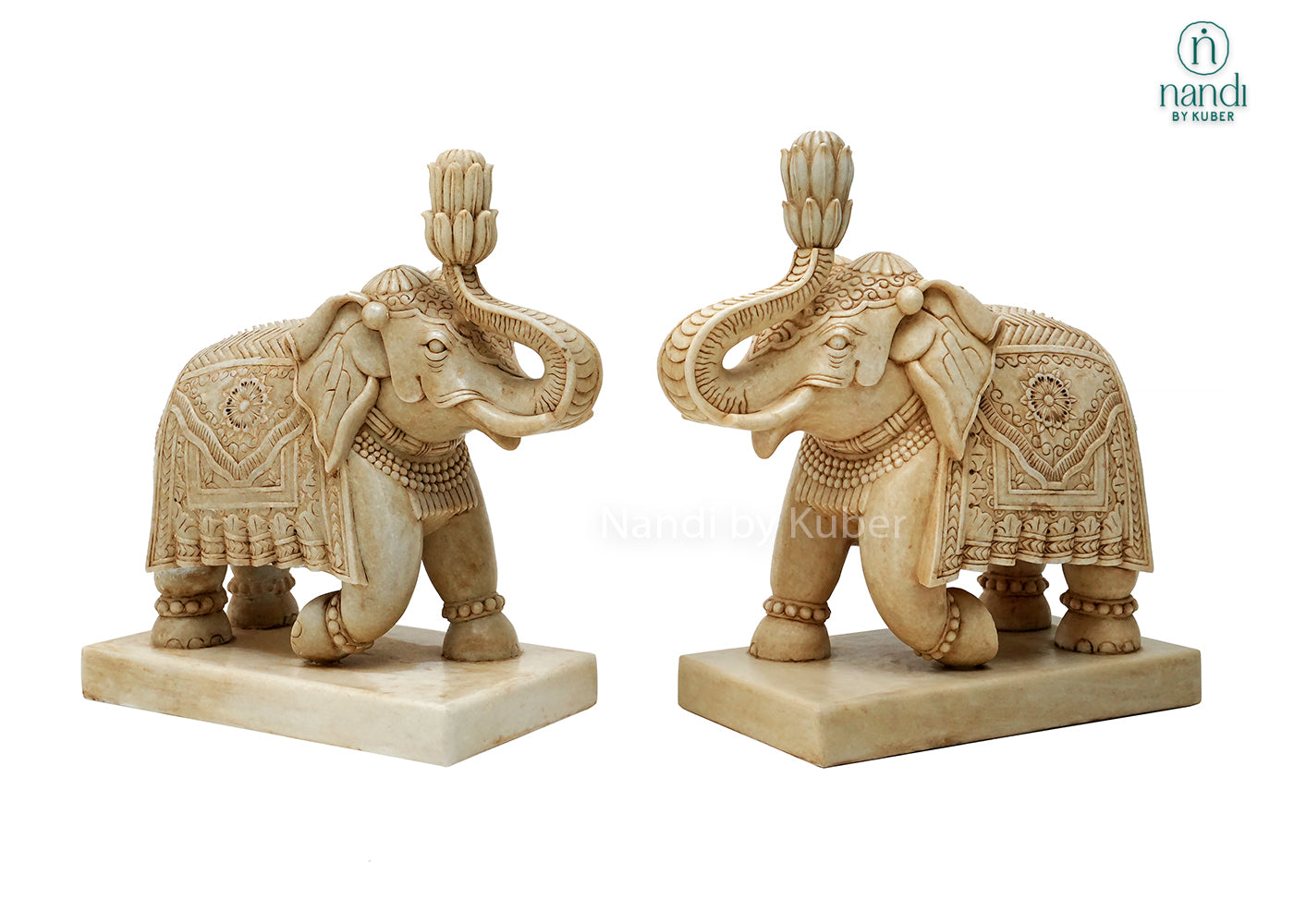 Handcrafted marble elephant statue with raised trunk, intricate traditional carvings, and decorative detailing on a marble base, ideal for home décor, Vastu, gifting, and luxury interior decoration.