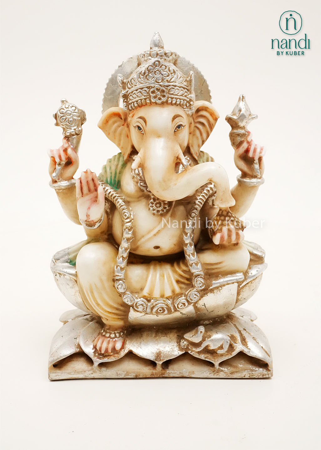 Handcrafted marble Ganesha idol seated on a lotus base with decorative silver finish and gemstone accents, ideal for home temples, spiritual décor, festive gifting, and Hindu worship spaces.