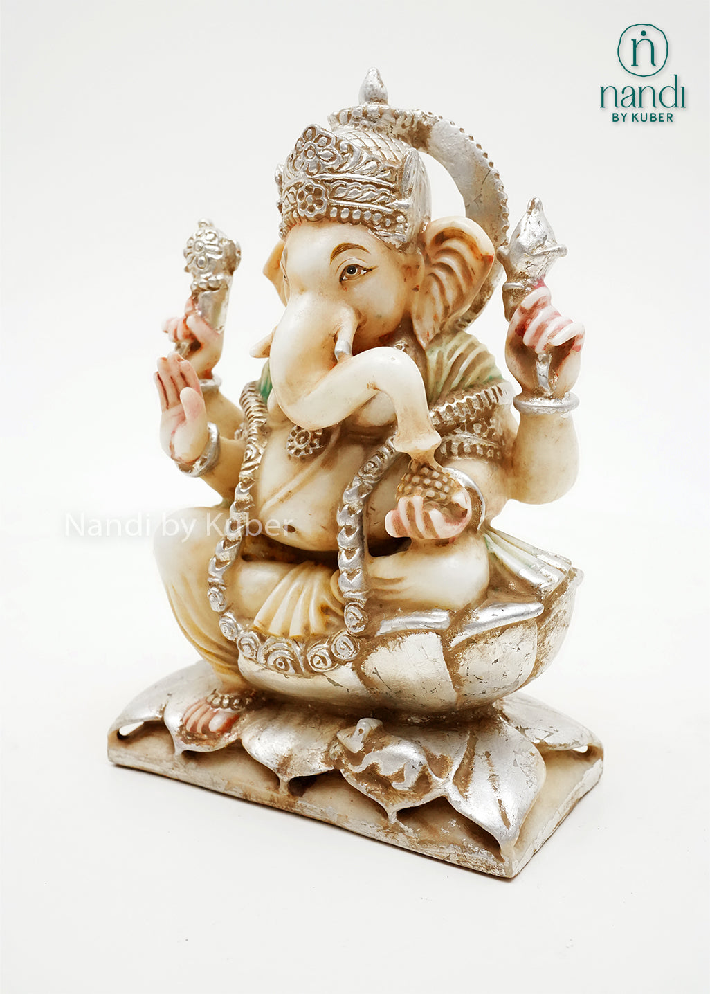 Handcrafted marble Ganesha idol seated on a lotus base with decorative silver finish and gemstone accents, ideal for home temples, spiritual décor, festive gifting, and Hindu worship spaces.