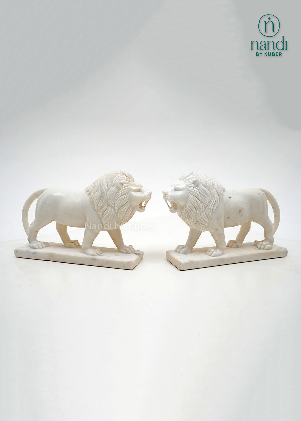 Set of two white marble lion figurines with detailed carving, decorative guardian lion statues for home décor, office display, entrance décor, and luxury gifting.