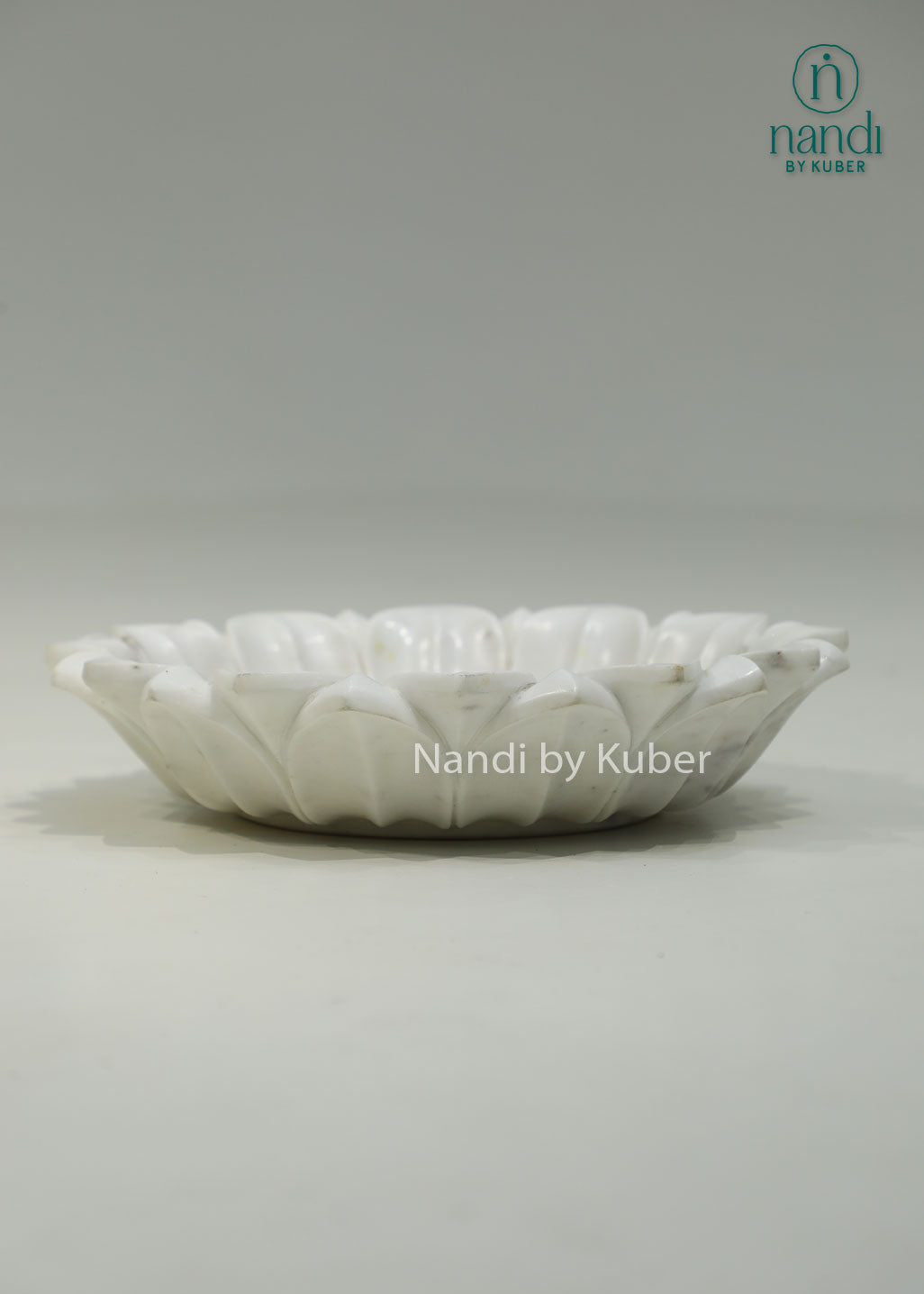 Handcrafted marble lotus urli with a graceful floral design, ideal for floating flowers, candles, and elegant decorative displays.
