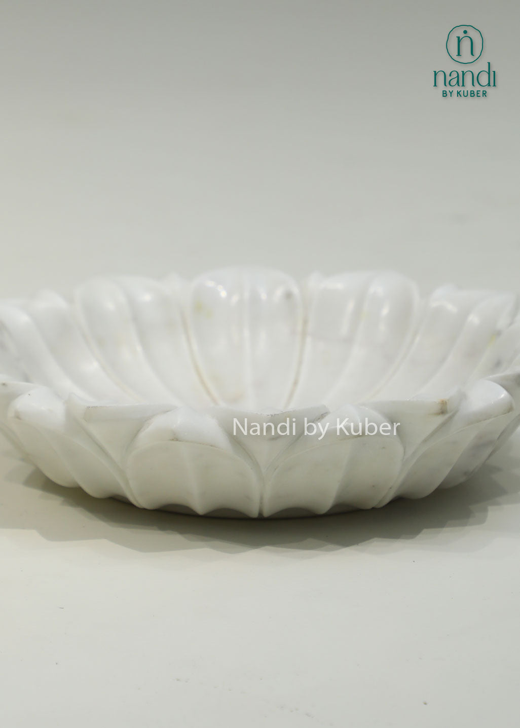 Handcrafted marble lotus urli with a graceful floral design, ideal for floating flowers, candles, and elegant decorative displays.