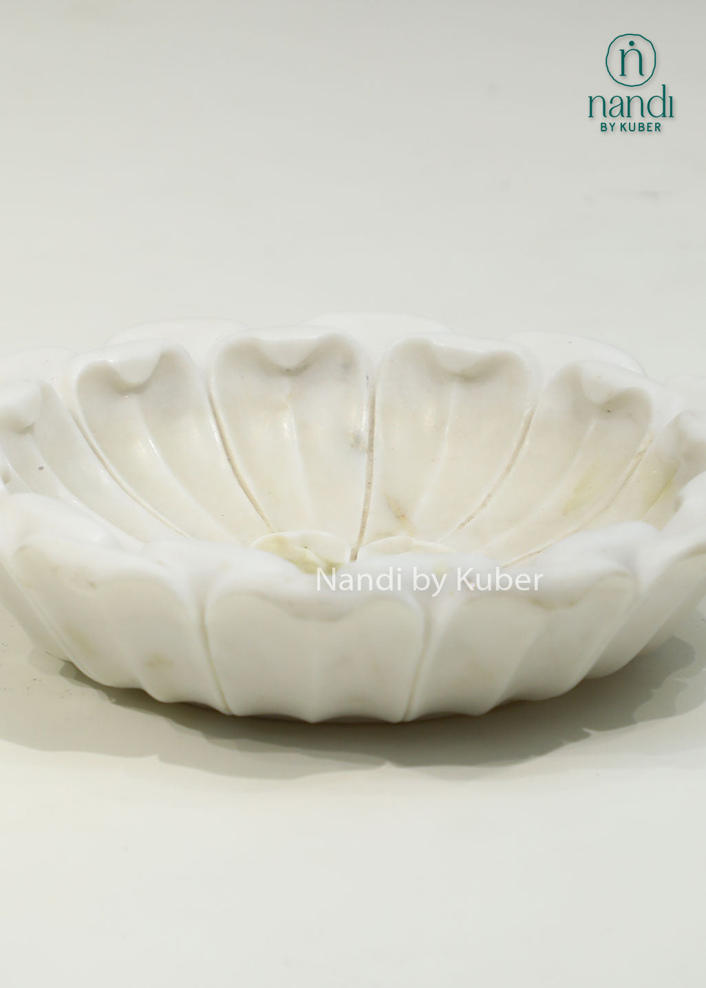 Handcrafted marble lotus urli with a graceful floral design, ideal for floating flowers, candles, and elegant decorative displays.