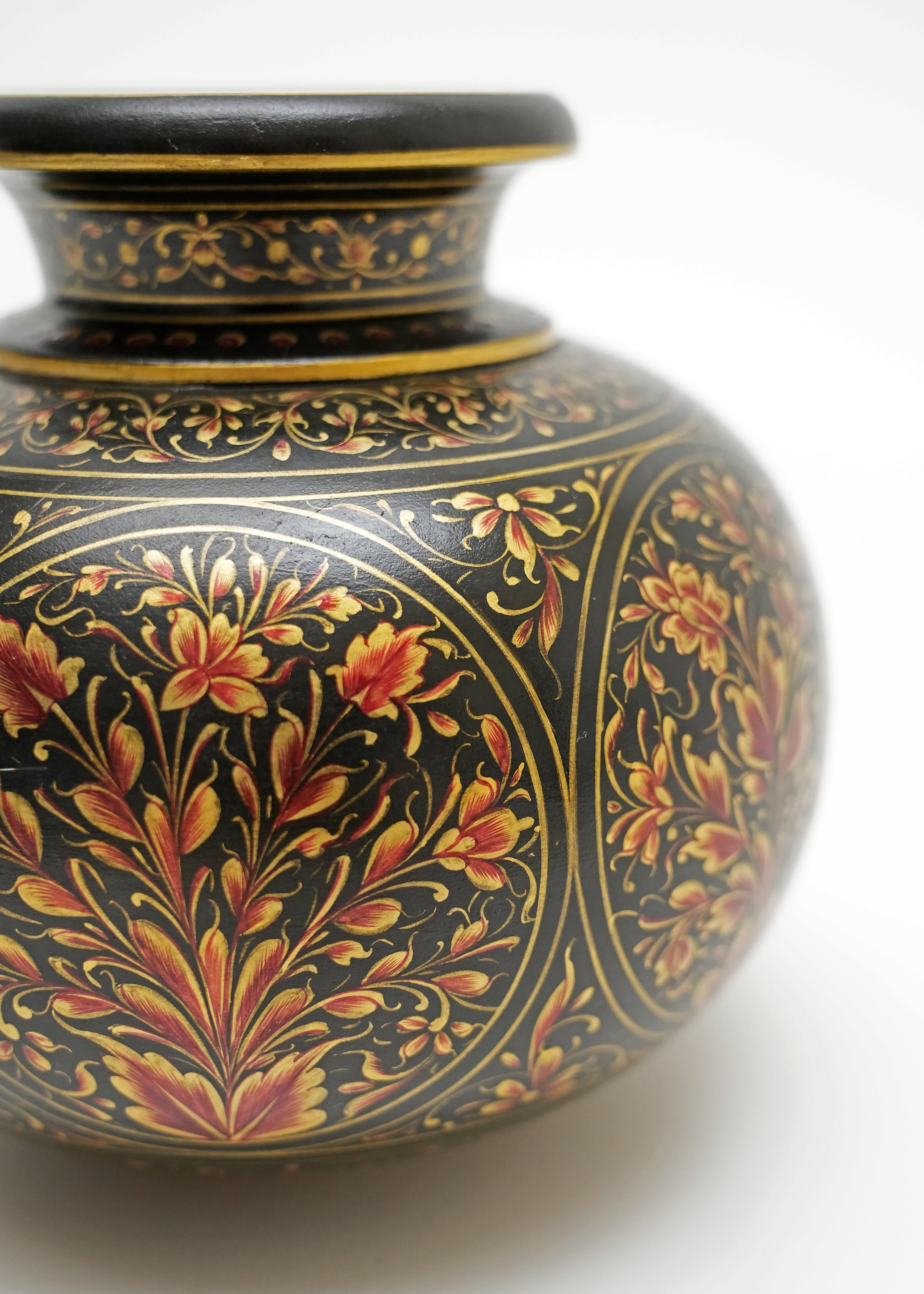 Decorative hand-painted marble matka vase with ornate floral artwork and gold detailing on a black finish, showcasing traditional Indian craftsmanship for luxury home décor and elegant interior styling.