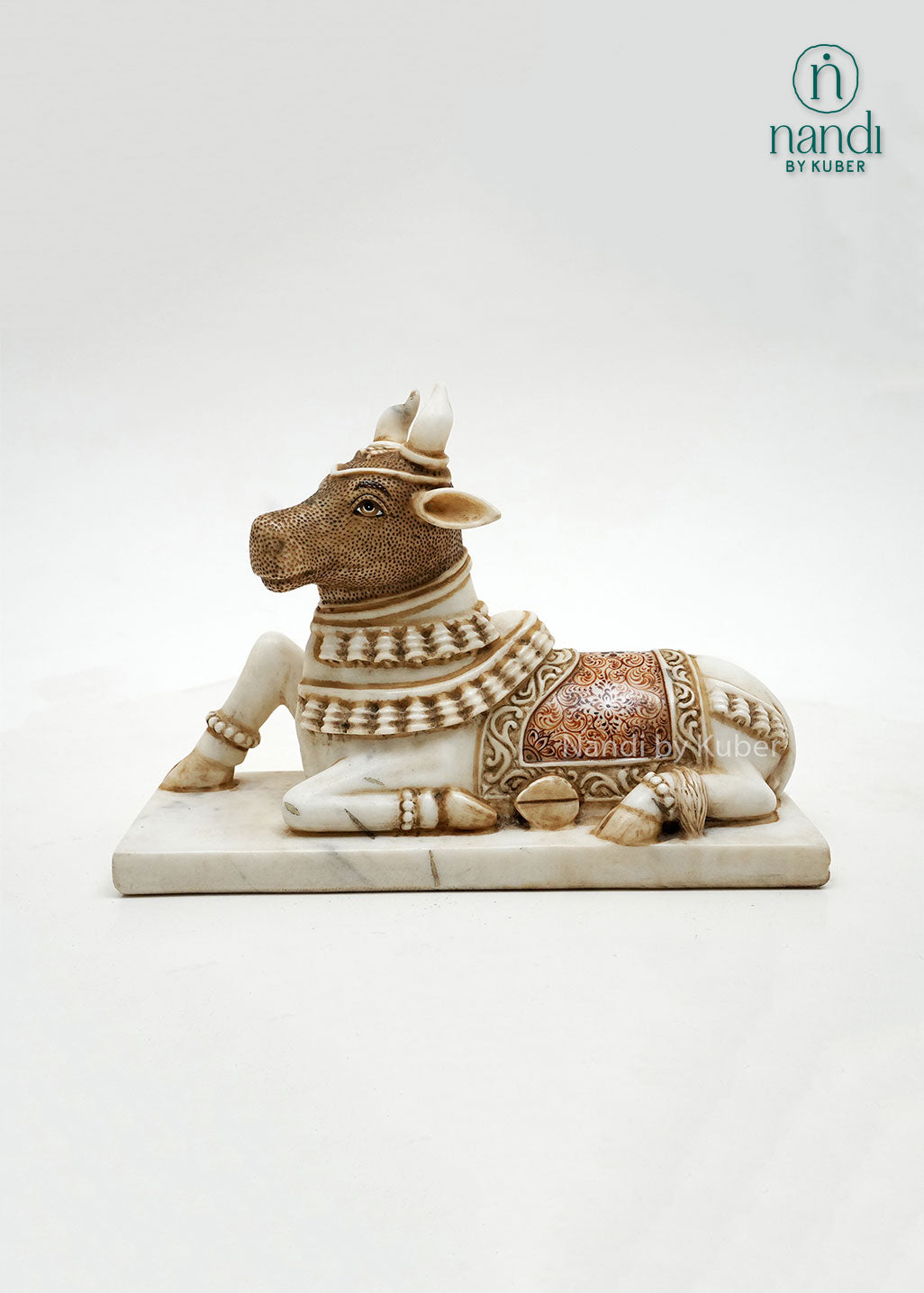Handcrafted marble Nandi bull sculpture with antique finish and intricate detailing, inspired by Hindu temple art, ideal for spiritual décor, pooja spaces, and traditional home interiors.
