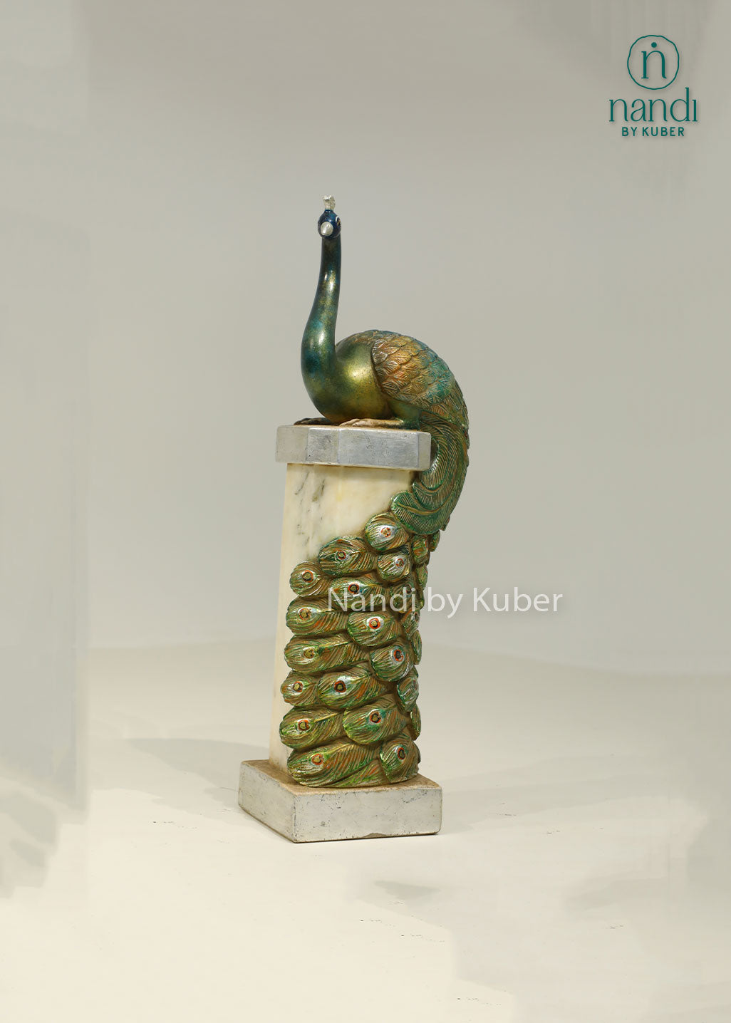 Decorative peacock sculpture on a marble-style pedestal with intricate detailing, ideal for adding elegance and artistic charm to any space.