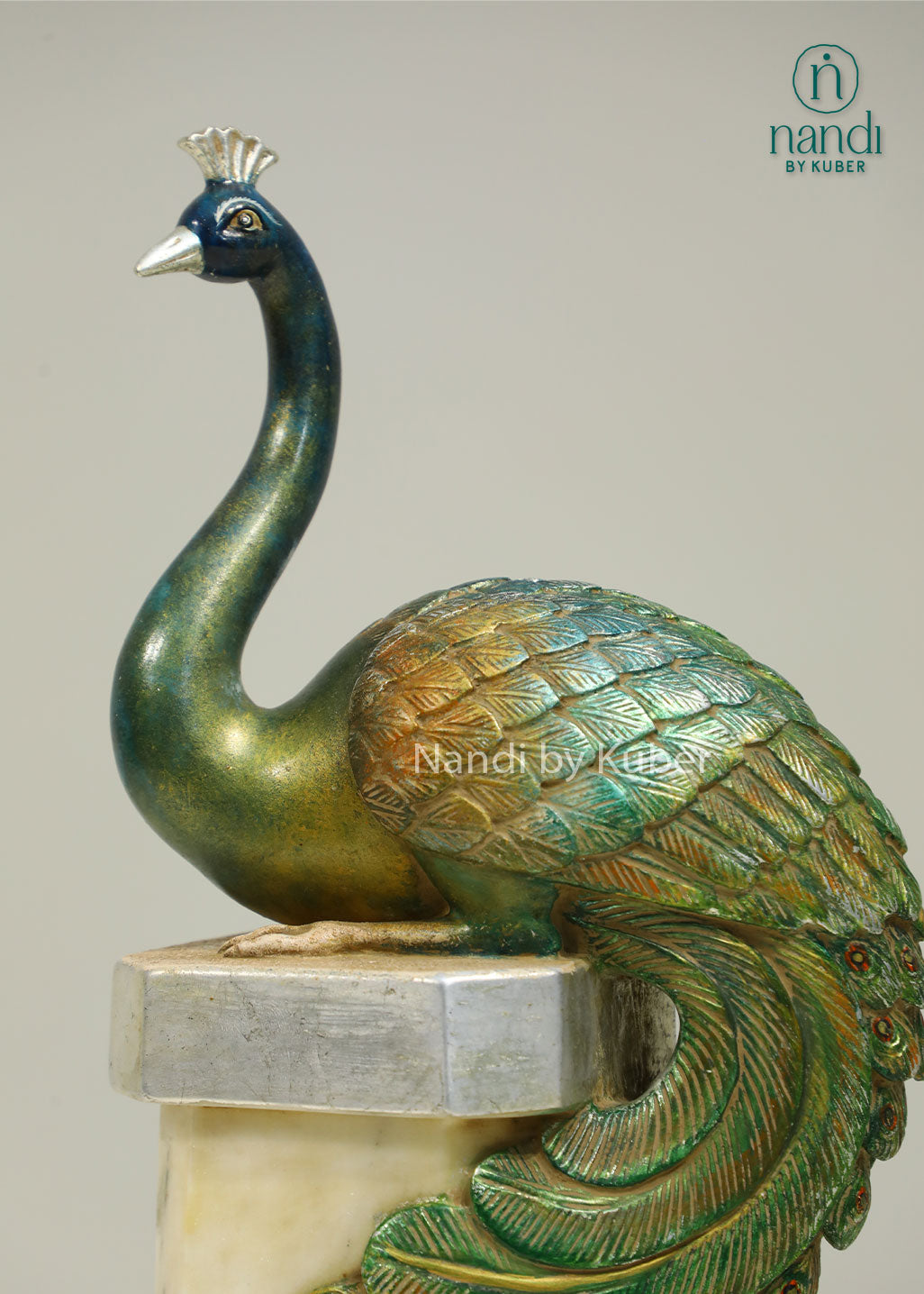 Decorative peacock sculpture on a marble-style pedestal with intricate detailing, ideal for adding elegance and artistic charm to any space.