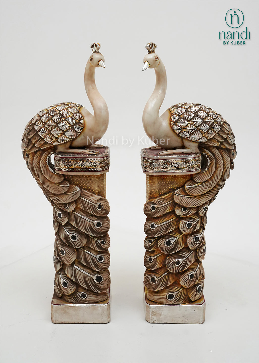 Decorative peacock pillar sculpture pair with intricate antique detailing, symbolizing beauty, prosperity, and timeless elegance.