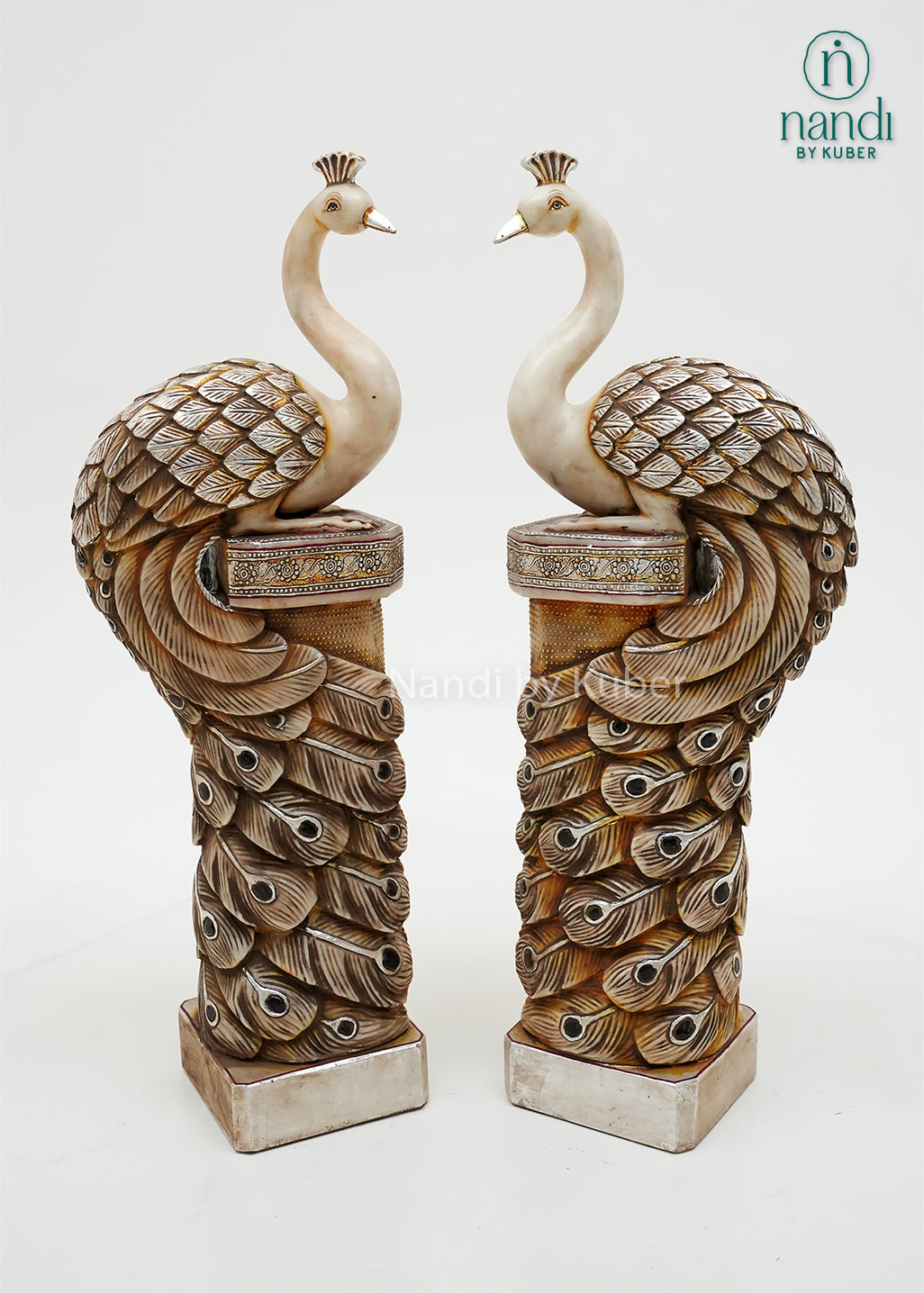 Decorative peacock pillar sculpture pair with intricate antique detailing, symbolizing beauty, prosperity, and timeless elegance.