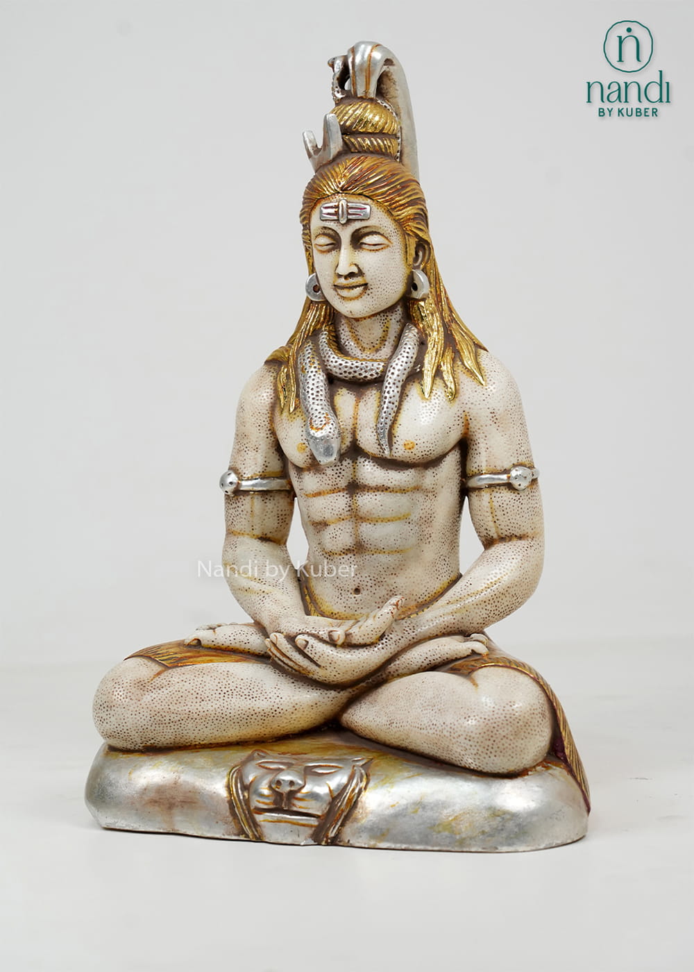 White marble-style Lord Shiva statue in a meditative pose with sacred adornments, antique gold accents, and a decorative pedestal base.