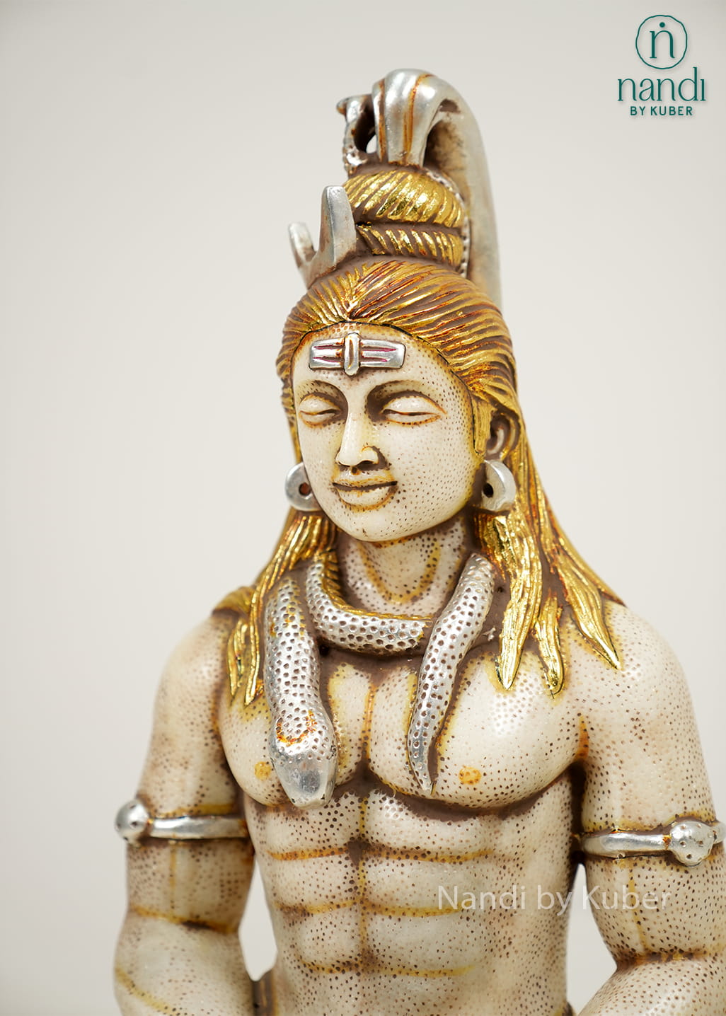 White marble-style Lord Shiva statue in a meditative pose with sacred adornments, antique gold accents, and a decorative pedestal base.