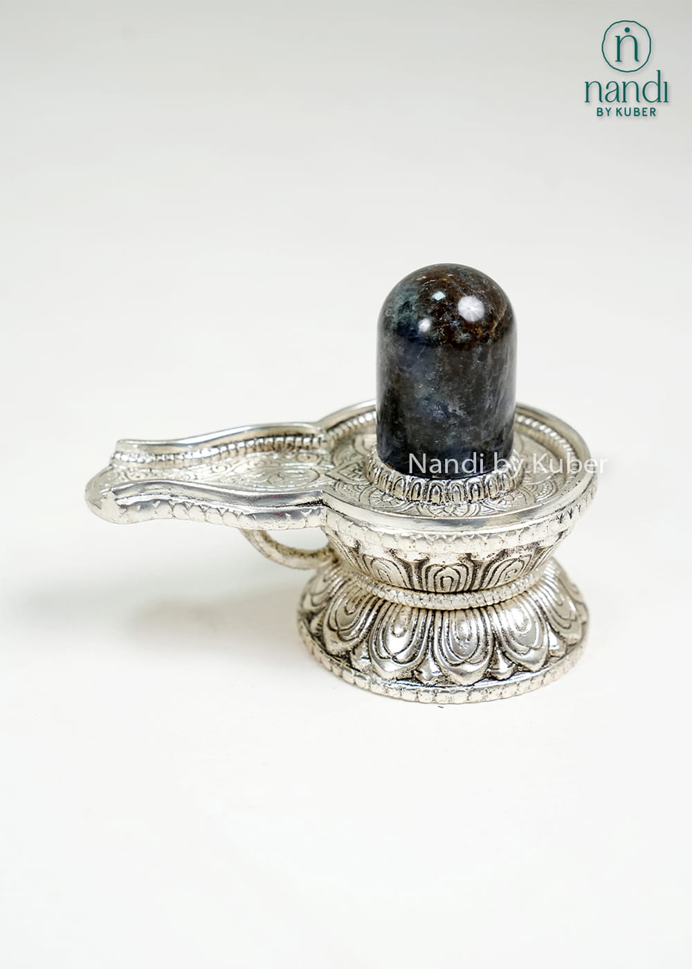 Semi-precious stone Shiva Lingam on ornate metal pedestal base