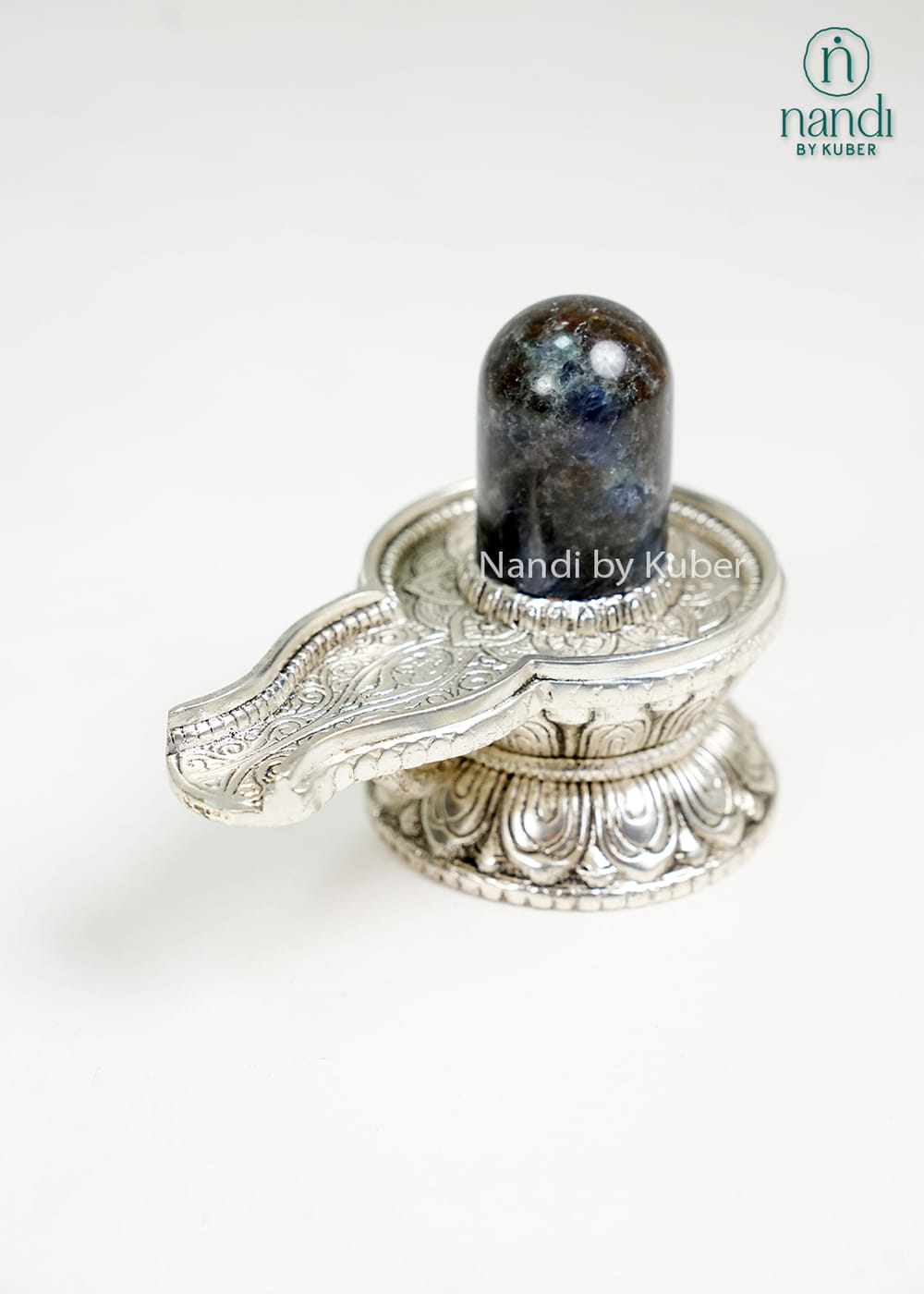 Semi-precious stone Shiva Lingam on ornate metal pedestal base