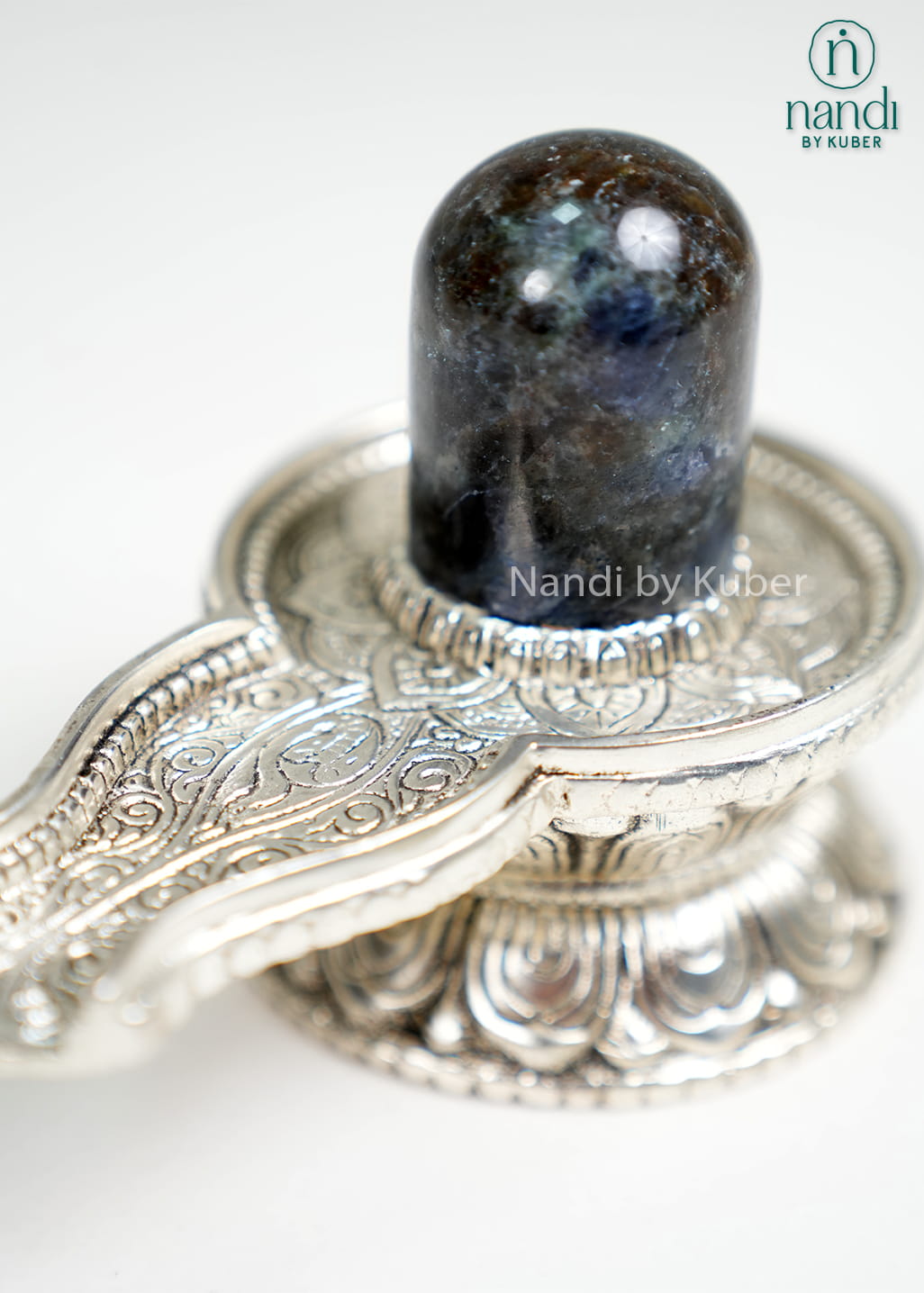 Semi-precious stone Shiva Lingam on ornate metal pedestal base