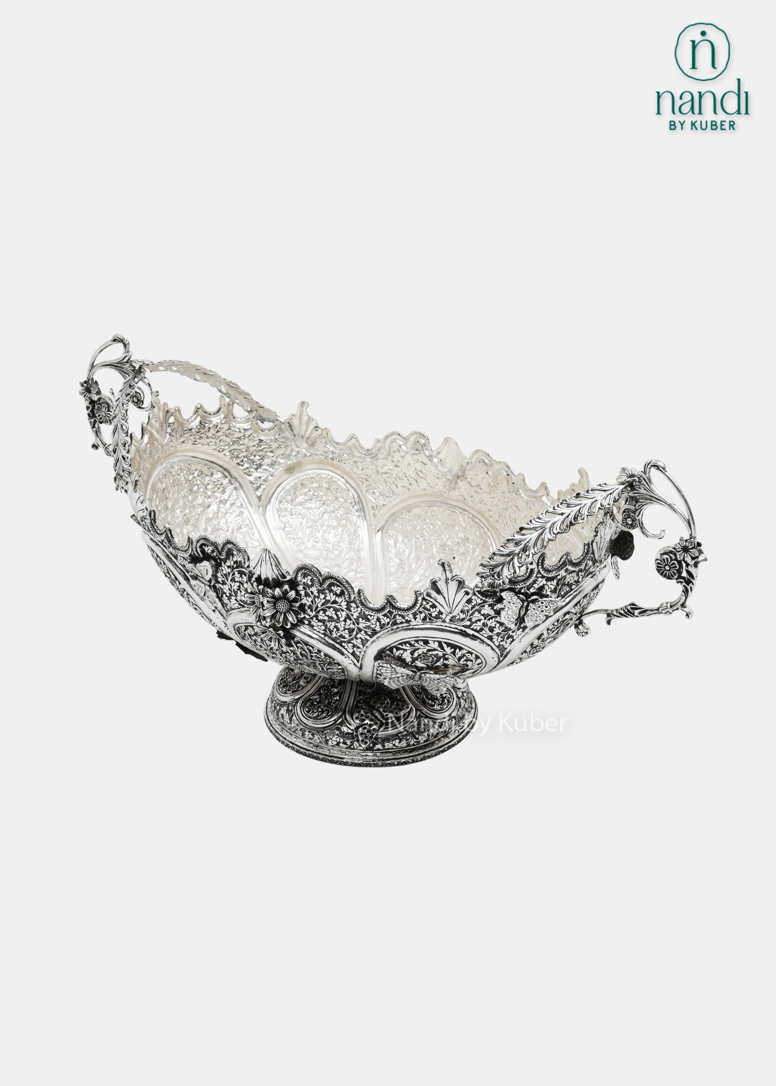 Decorative silver fruit bowl with floral carving and ornate side handles