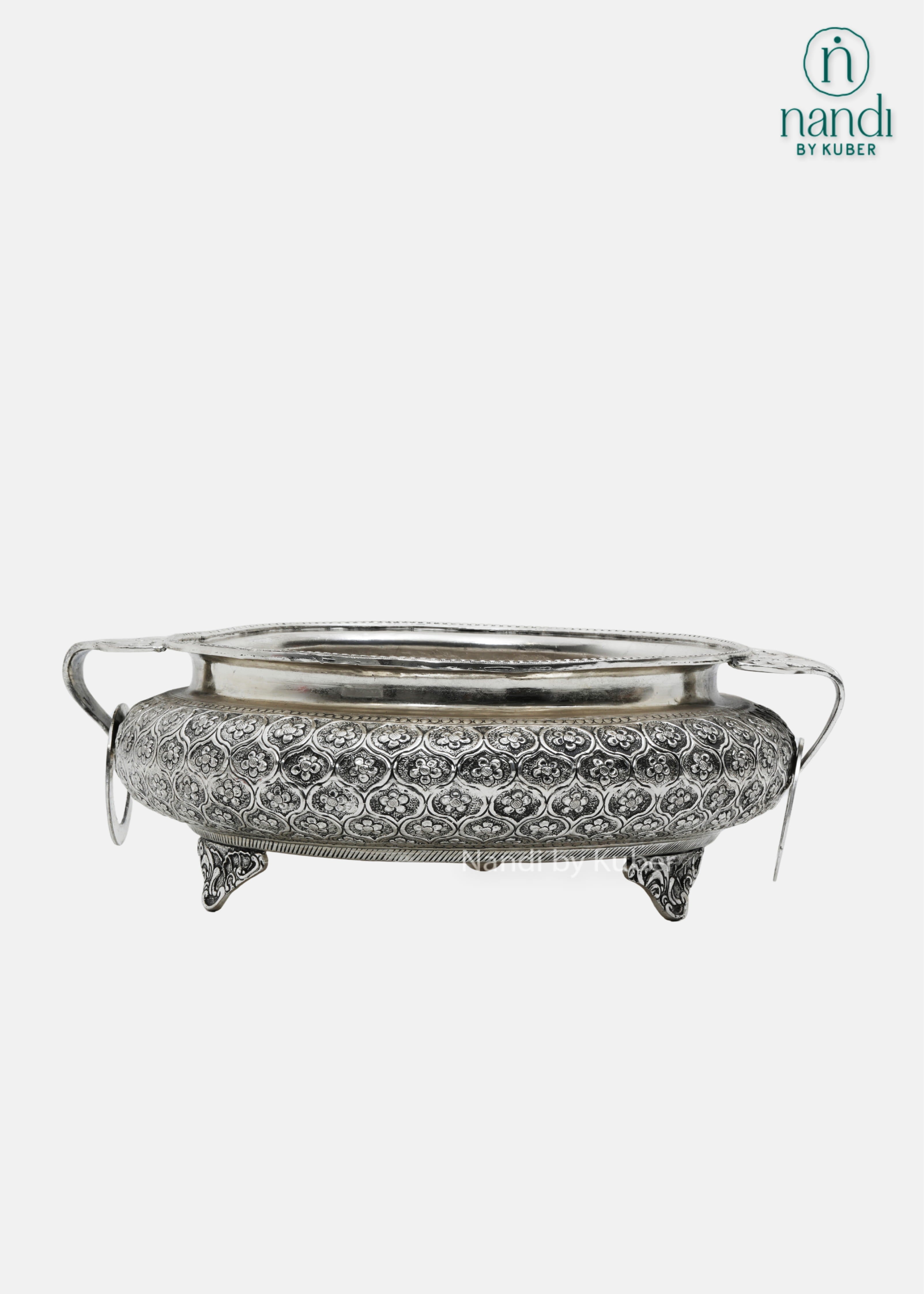 Decorative silver metal serving bowl with handles and intricate floral carving