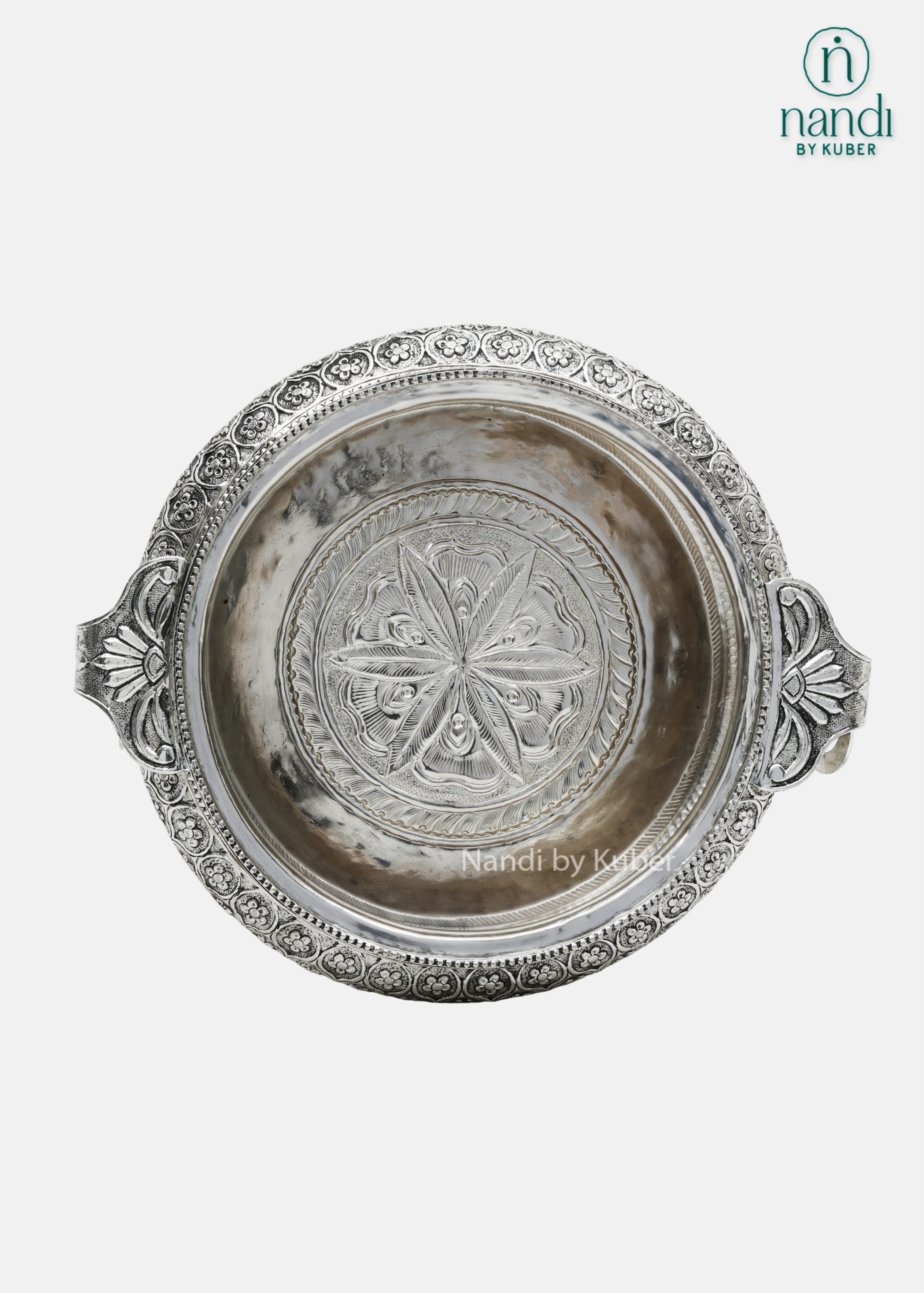Decorative silver metal serving bowl with handles and intricate floral carving