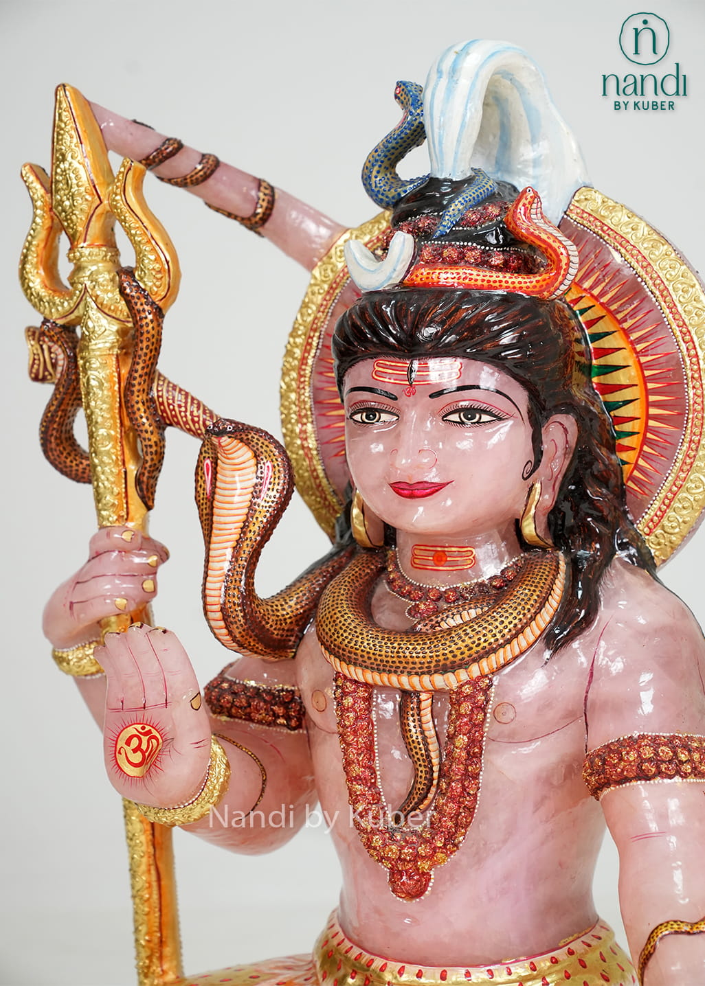 Rose quartz Lord Shiva statue with trident, serpent detailing, and gold accents
