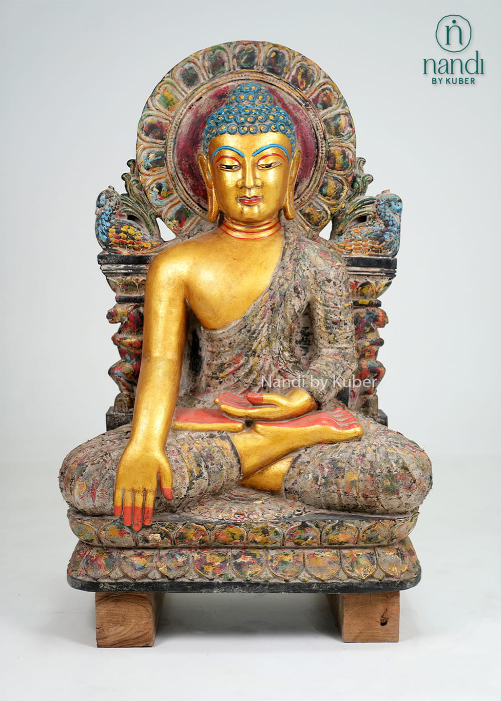 Antique-finish seated Buddha statue with gold-tone detailing, ornate arch backdrop, and handcrafted decorative artistry.