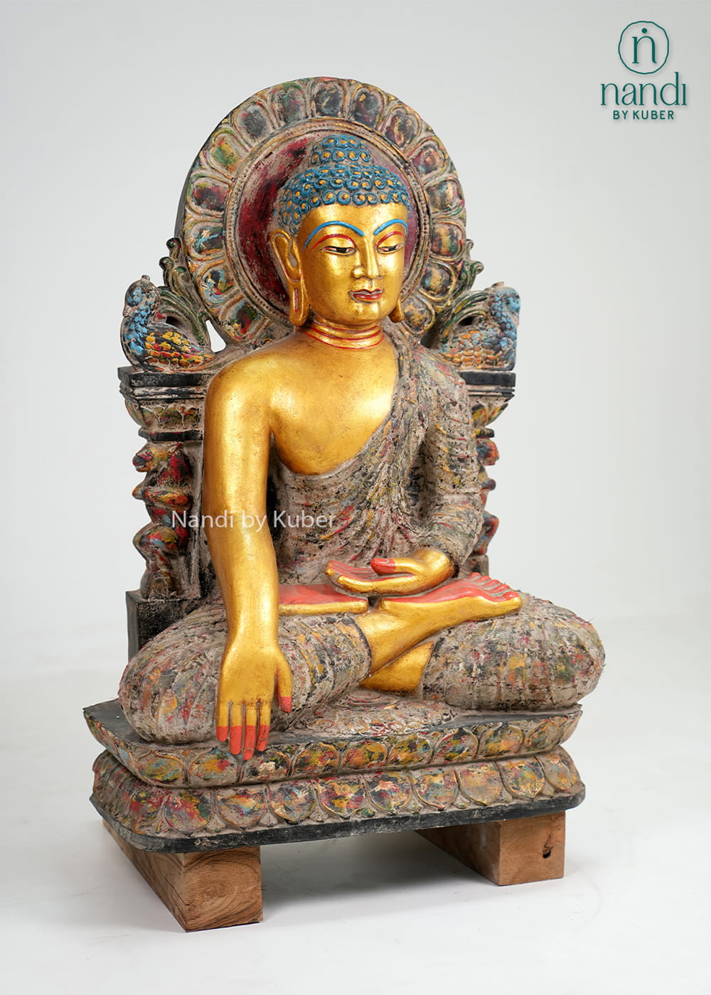 Antique-finish seated Buddha statue with gold-tone detailing, ornate arch backdrop, and handcrafted decorative artistry.